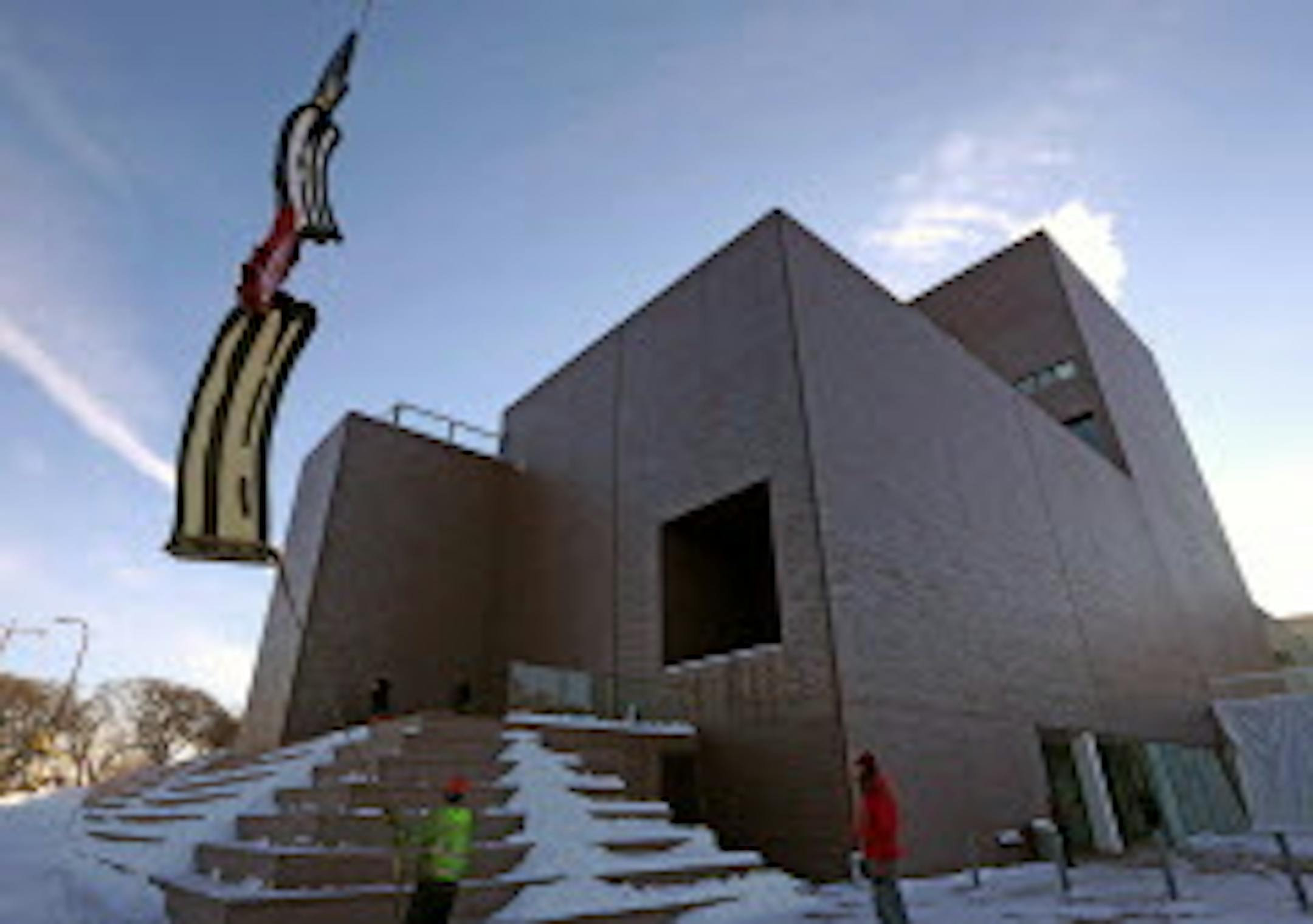 Crews from the Walker Art Center and Rocket Crane re-install Roy Lichtenstein's Salute to Painting on the Vineland Terrace on 12/12/13. The sculpture is a big colorful brush stroke by the late Roy Lichtenstein, which was given to the Walker back in the 1990s by former board members in honor of then director Martin Friedman. The sculpture has been in storage for past year while the 1971 wing of the building, designed by architect Edward Larrabee Barnes, was re-bricked. The $8 million re-bricking project is now complete, so the sculpture is being reinstalled.]  Bruce Bisping/Star Tribune  bbisping@startribune.com