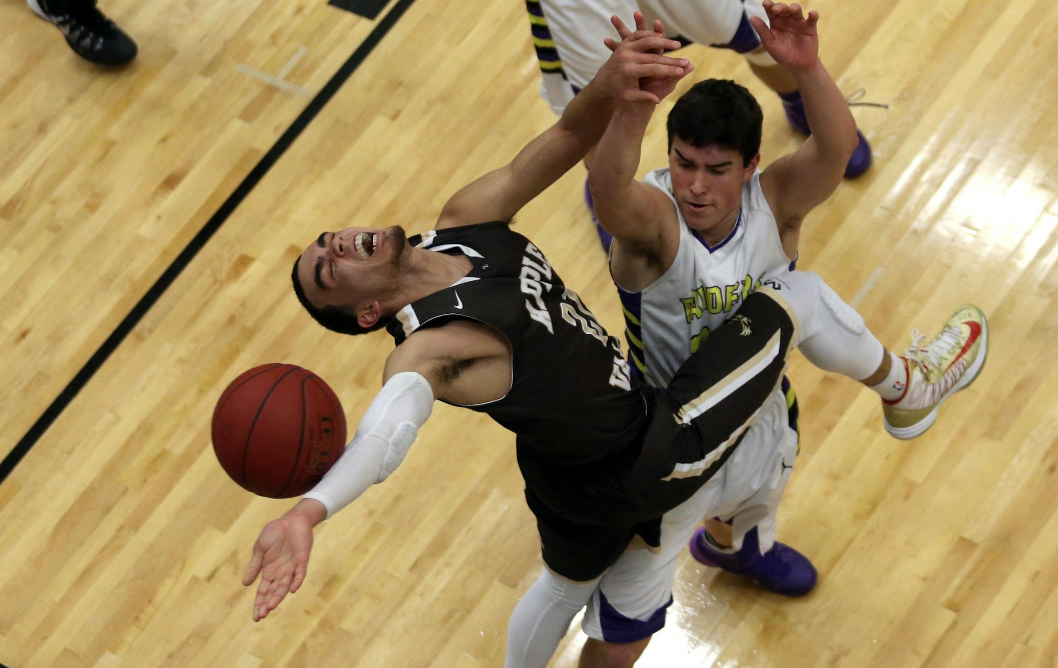 Apple Valley's Tyus Jones got fouled on the way to the basket by Cretin Durham's George Hottinger during the second half.