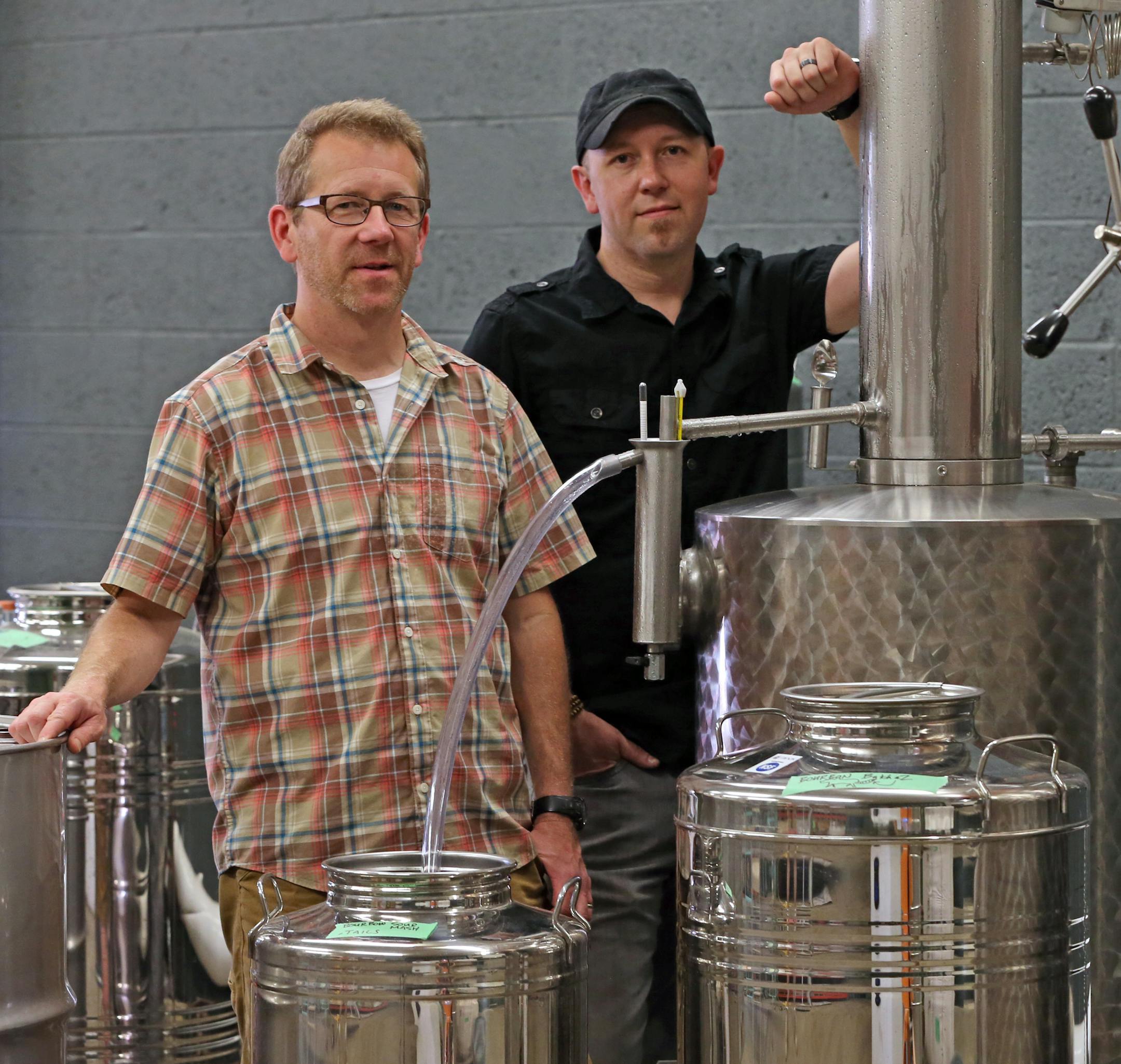 (left to right) Robert McManus and Lee Egbert of 11 Wells Distillery were photographed in the distillery room on 6/28/14. The old Hamm's brewery building is getting back in the booze game, with 11 Wells Distillery and Flat Earth Brewing now up and running -- "Hamm's building brews anew."] Bruce Bisping/Star Tribune bbisping@startribune.com Robert McManus, Lee Egbert/source.