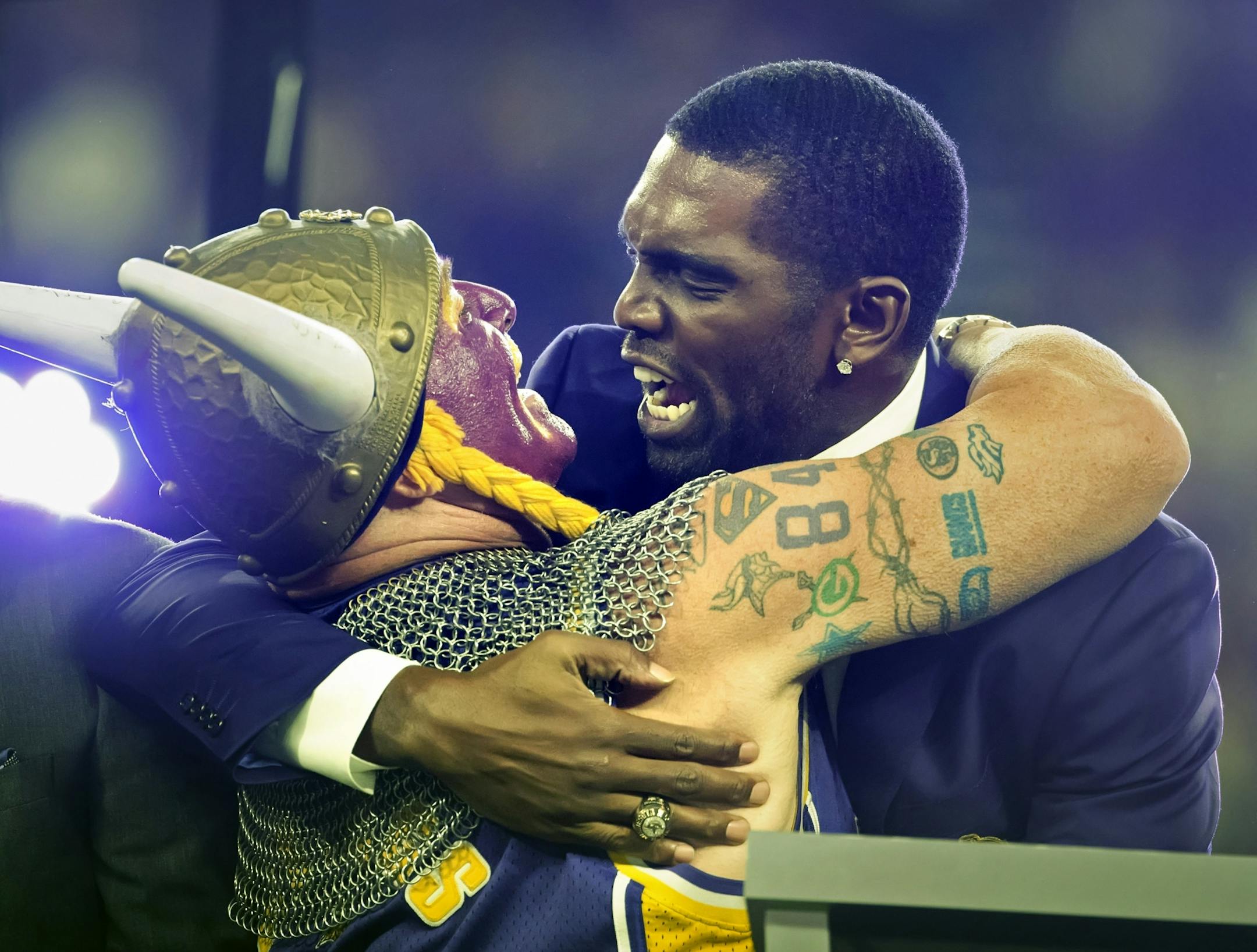 Former Viking Randy Moss hugs superfan Syd Davy, who often caught Randy Moss as he jumped into the stands after scoring a TD at the metrodome. Moss was inducted into the Vikings Ring of Honor Monday night at U.S. Ban Stadium.