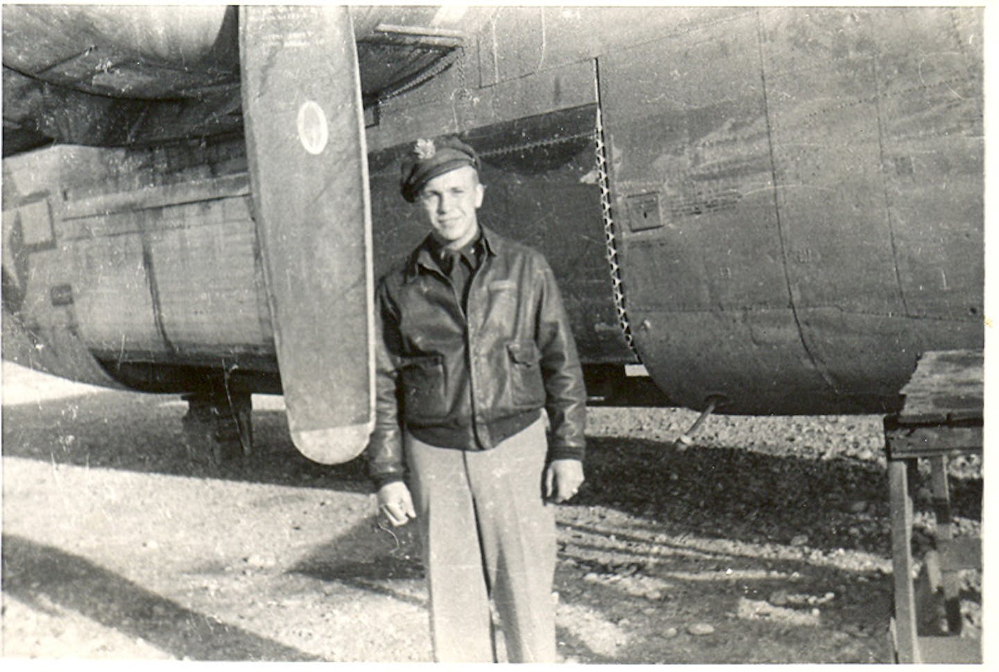 Lowell Swenson is shown with a bomber during World War II.