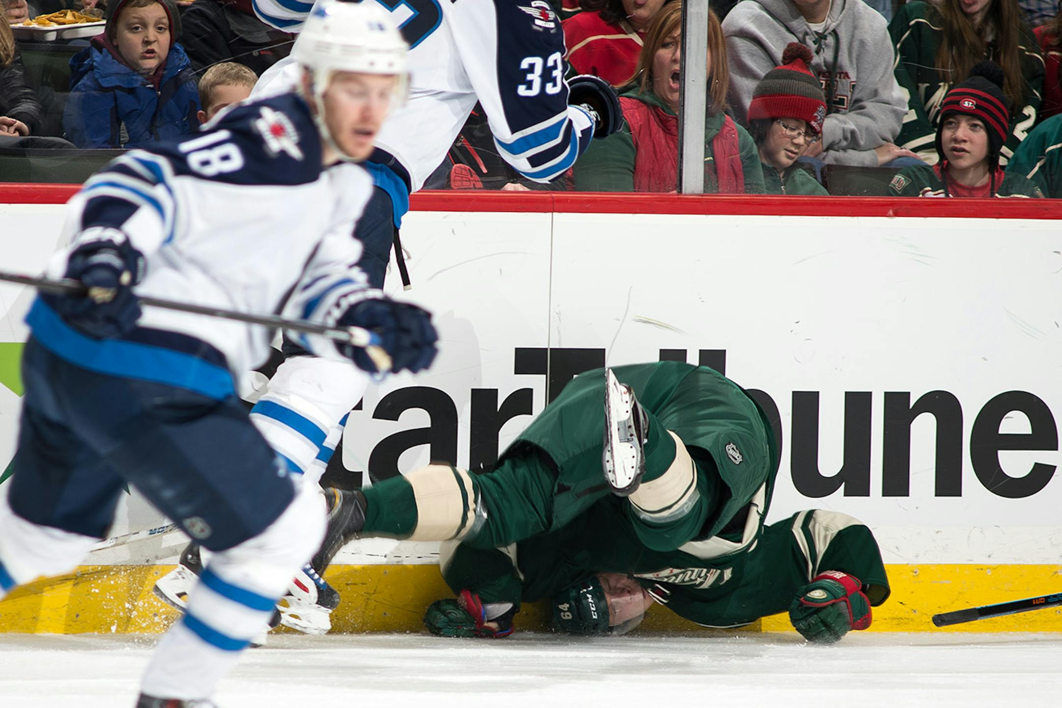 Minnesota Wild center Mikael Granlund (64) is upended after taking an illegal check by Winnipeg Jets defenseman Dustin Byfuglien (33) during the third period.
