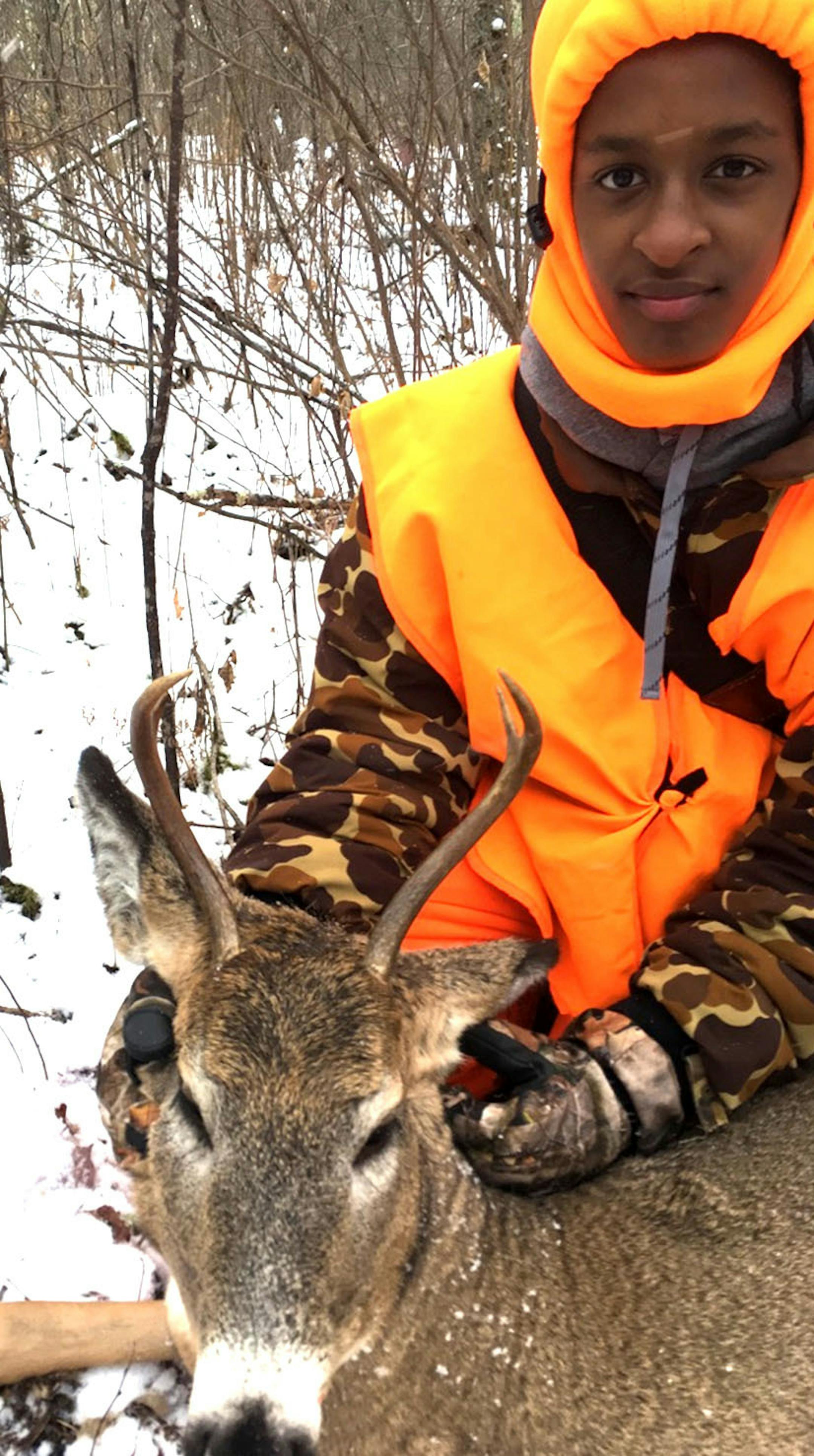 Aaron Sundberg, 14, of Minneapolis, with his first deer. He shot this yearling buck shot with a .30-30 rifle on land owned by his grandfather and uncles near McGregor, Minn.