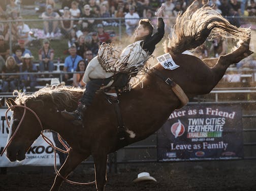 Kooper Heimburg of Marshall, Missouri gets a wild ride on Illegal Smile during a bareback riding heat in Corcoran, Minn., on Thursday, July 6, 2023. Thursday was the first day of the 42nd Hamel Rodeo &amp; Bull Ridin' Bonanza.