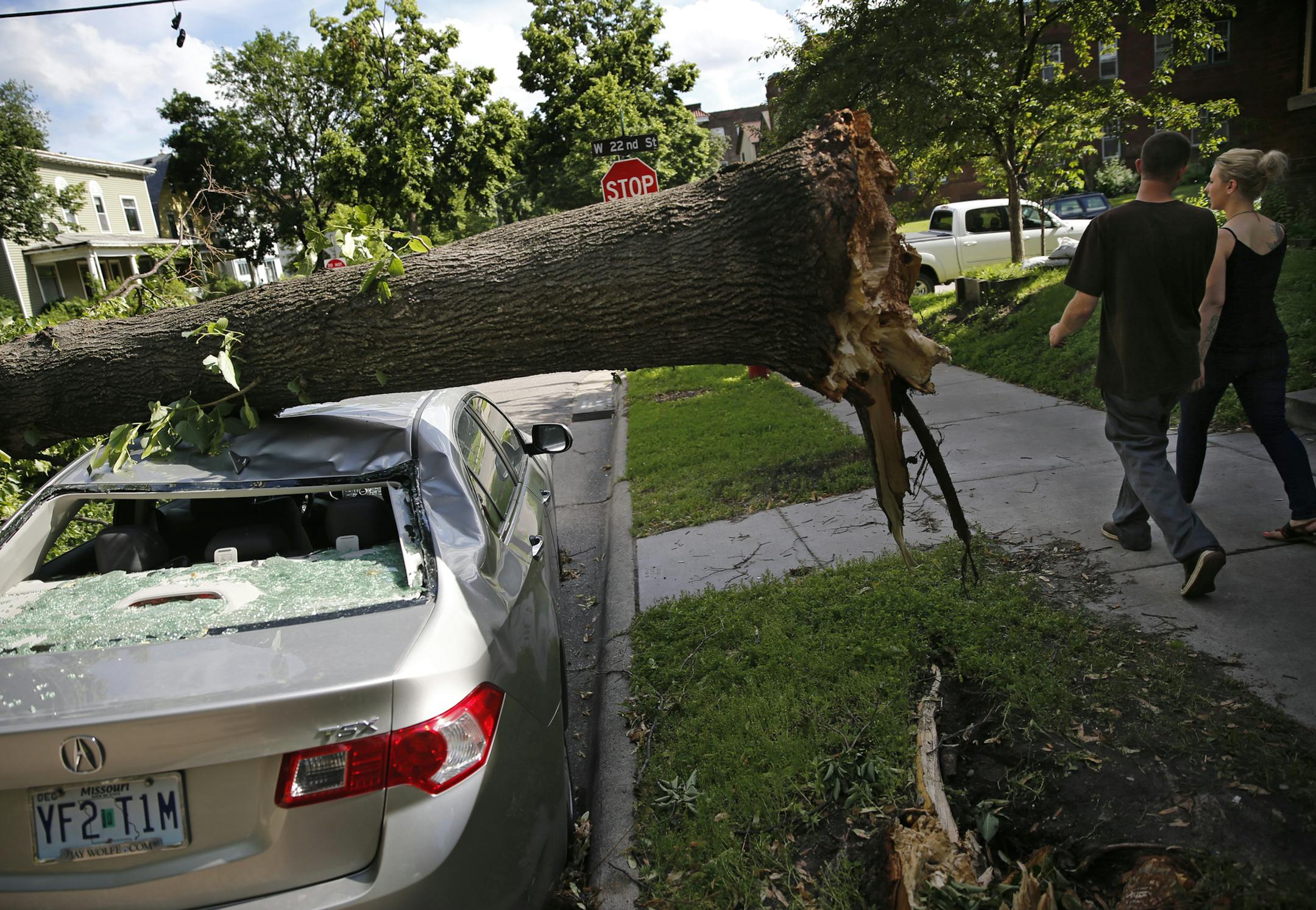 In the Whittier neighborhood of Minneapolis, a tree perfectly balanced itself on top of this sedan and a s.u.v.] richard tsong-taatarii@startribune.com