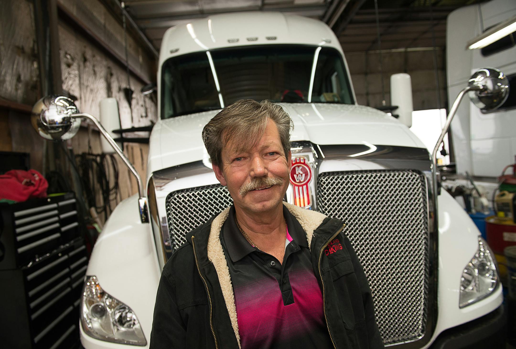 Truck driver Driver Bill McMahon, who was recently rehired by his former employer Copeland Trucking, stands in front of the brand new $145,000 rig from the company's location in Fridley, Minnesota on October 2, 2014. [ Angela Jimenez/Special to the Star-Tribune angelajime@gmail.com Assignment #20036493A_ SLUG: TRUCK100514_ EXTRA INFORMATION: Minnesota's severe trucker shortage is forcing wages up and creating accommodating working conditions for drivers. That means shorter trips and less time aw