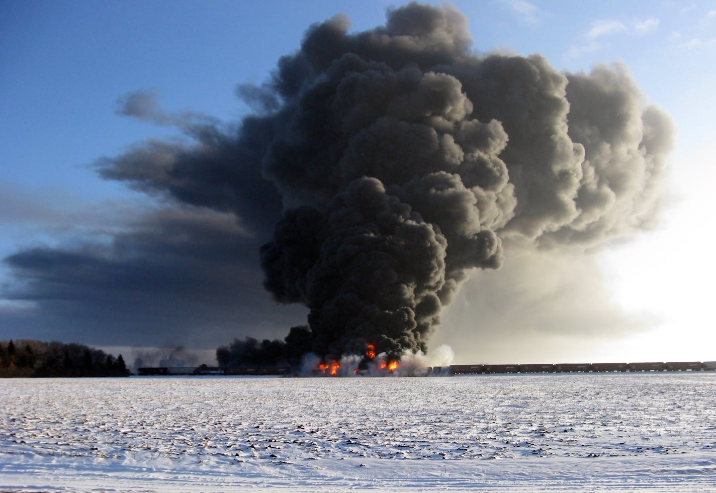 This photo provided by Cass County Commissioner Ken Pawluk shows a train derailment and fire west of Casselton, N.D., Monday, Dec. 30, 2013.