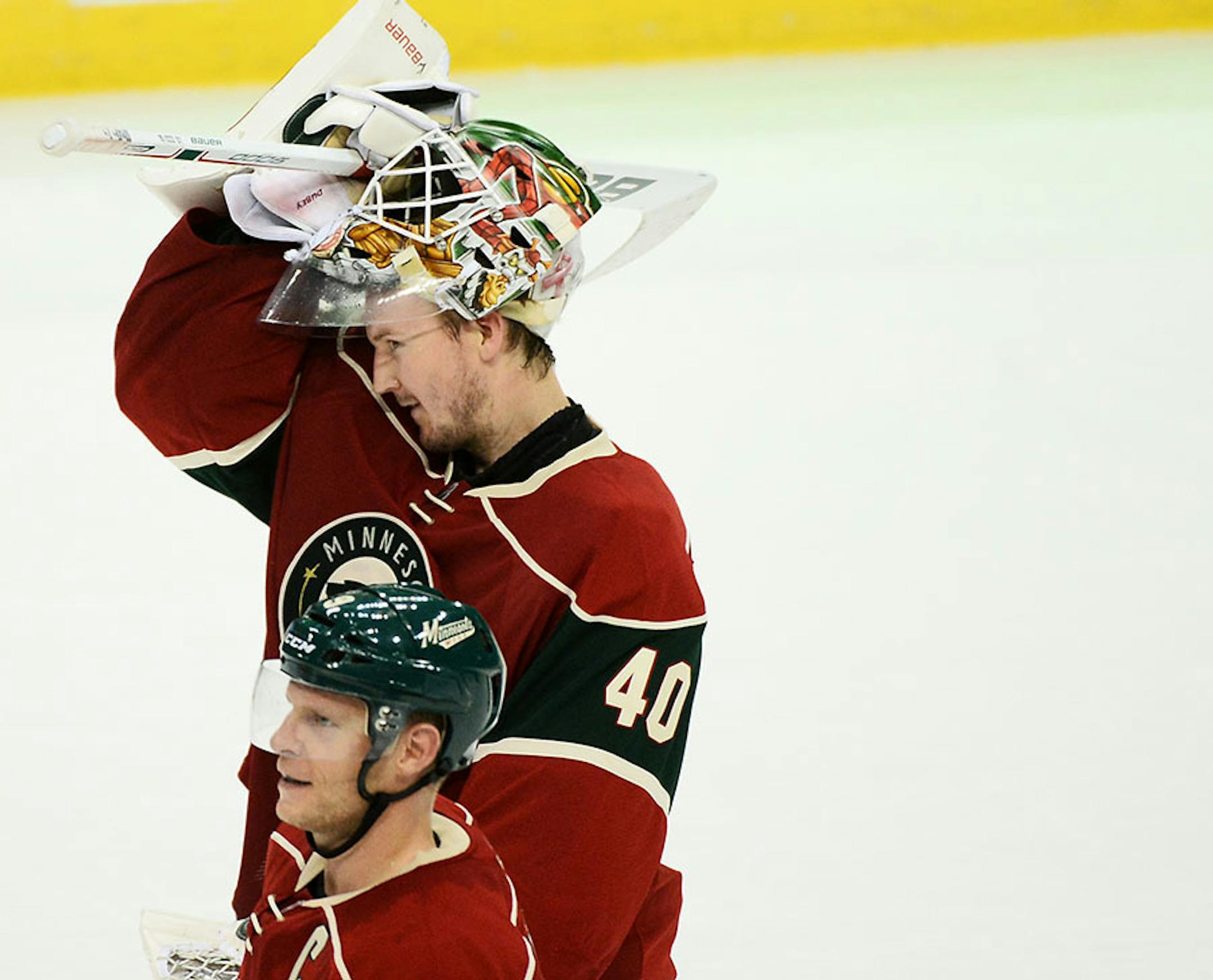 Minnesota Wild goalie Devan Dubnyk (40) took off his helmet while skating off the ice after the team's 3-0 victory over the Anaheim Ducks Saturday.