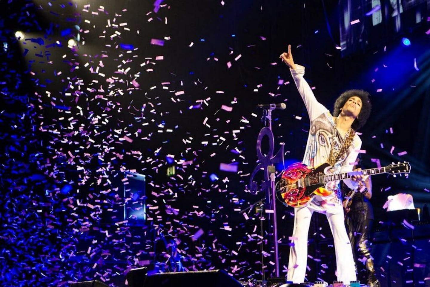 In this 2014 photo released by NPG Records, Prince performs in Birmingham, England.