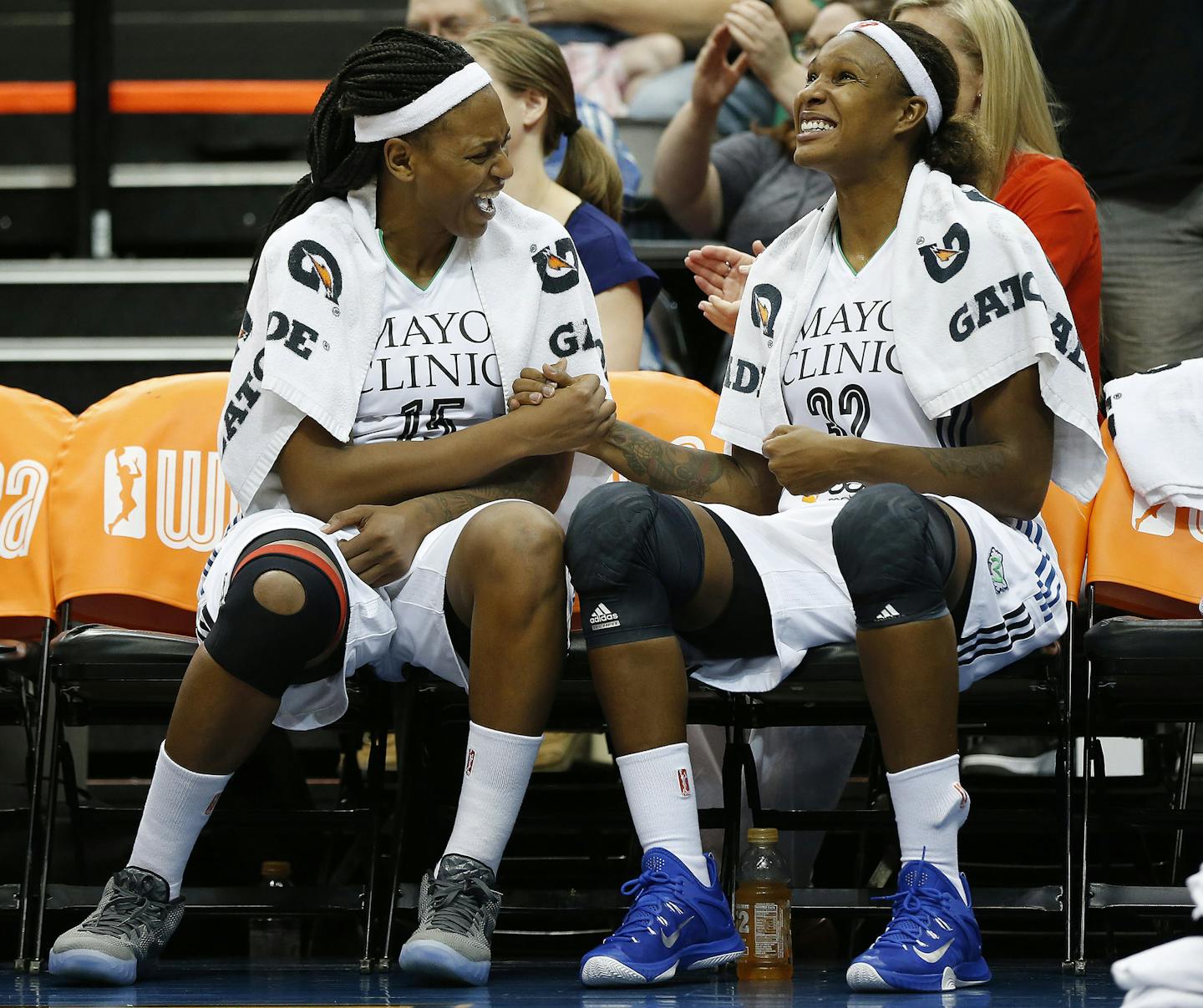 Minnesota Lynx forwards Asjha Jones, left, and Rebekkah Brunson celebrate on the bench as their team takes the lead during the second half of a WNBA basketball game against the Phoenix Mercury, Sunday, Aug. 30, 2015, in Minneapolis. The Lynx won 71-61. (AP Photo/Stacy Bengs) ORG XMIT: MIN2015091719161618