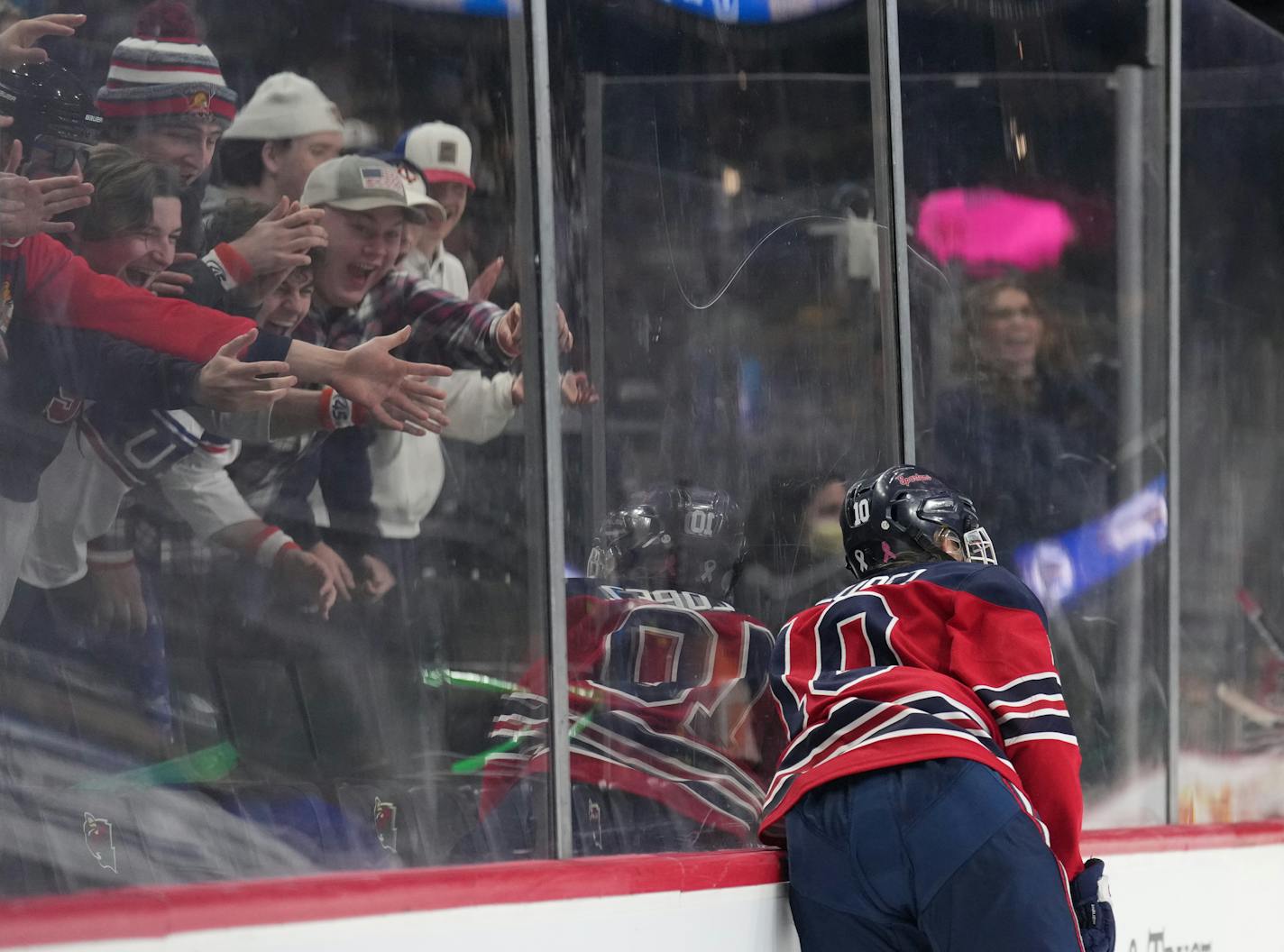 Orono fans cheer as forward Zoe Lopez (10) throws herself against the glass after scoring a goal in the second period at Xcel Energy Center in St. Paul, Minn., on Friday, Feb. 24, 2023. Orono took on Proctor-Hermantown in a Class 1A semifinal. ] SHARI L. GROSS • shari.gross@startribune.com