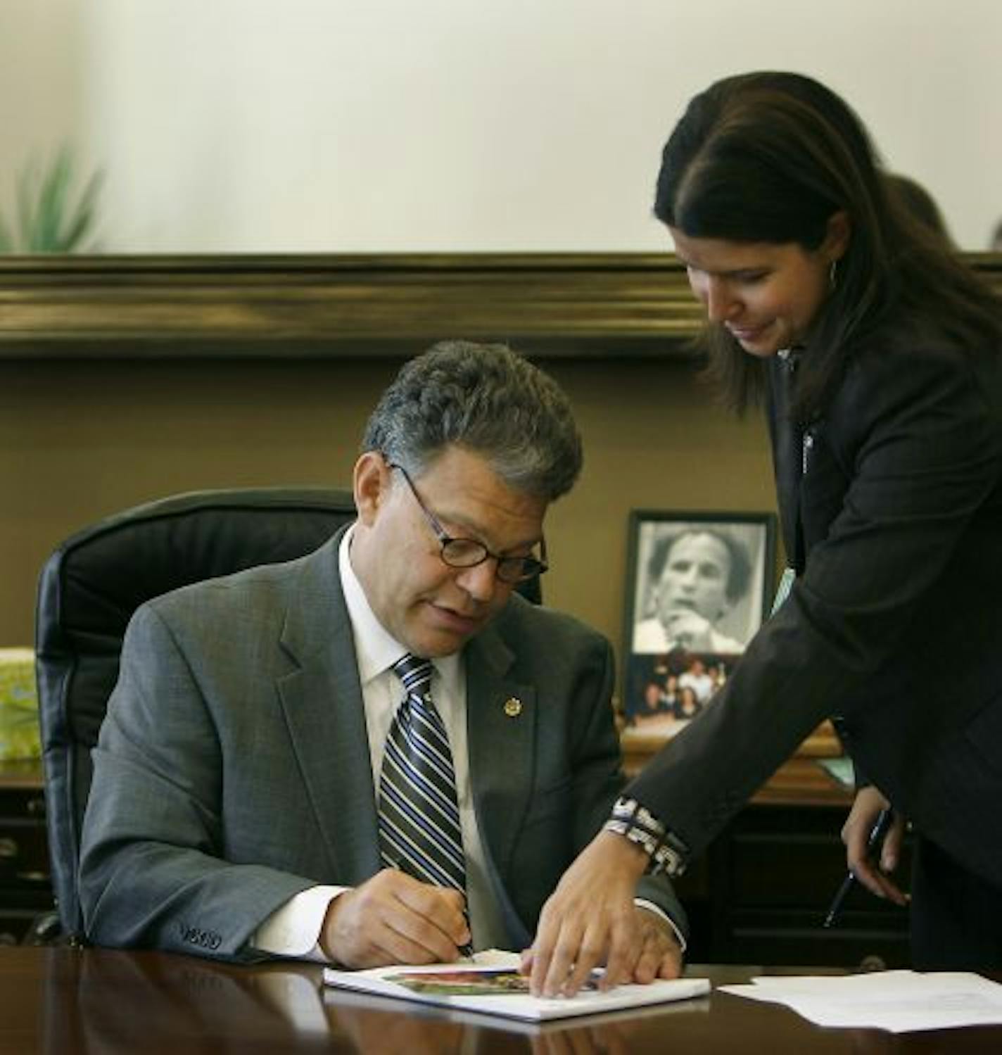 With a black and white photo of former Senator Paul Wellstone behind his desk, Minnesota Senator Al Franken conducted business alongside Executive Assistant Jamie Drogin in his new office at the Hart Senate Office Building.