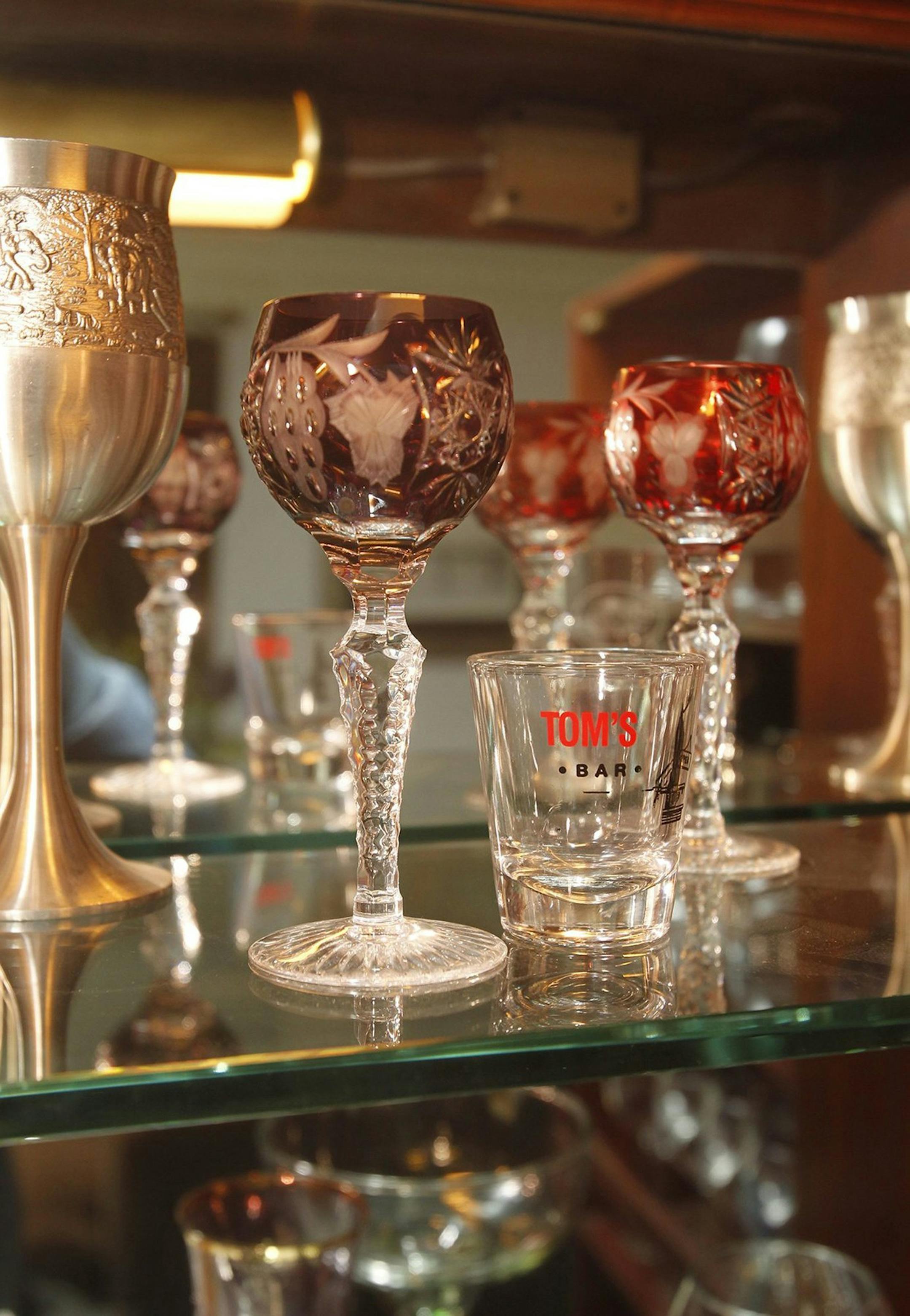 A wide range of glass souvenirs from fine cordial glasses to shot glasses are displayed in the glass collection of Allison Perley-Harter in a liquor cabinet in her home in Hudson, Ohio, on Oct. 26, 2013. (Karen Schiely/Akron Beacon Journal/MCT)
