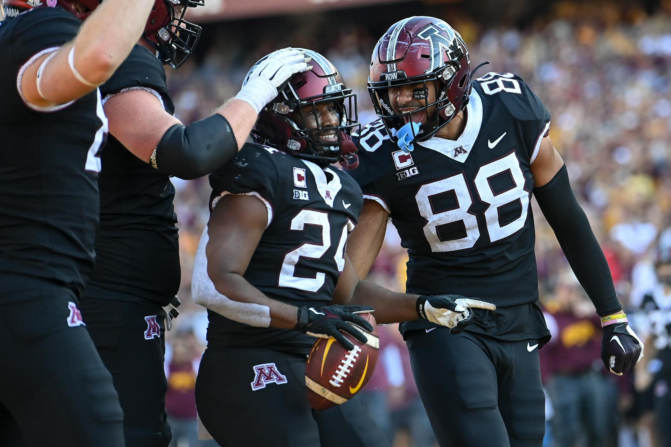 Minnesota Golden Gophers running back Mohamed Ibrahim (24) celebrates his second of two second quarter touchdowns against the Rutgers Scarlet Knights alongside teammates, including tight end Brevyn Spann-Ford (88).