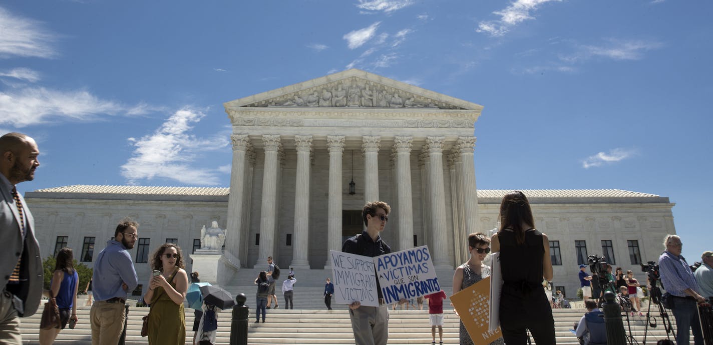 Demonstrators outside the U.S. Supreme Court building in Washington, June 26, 2017.