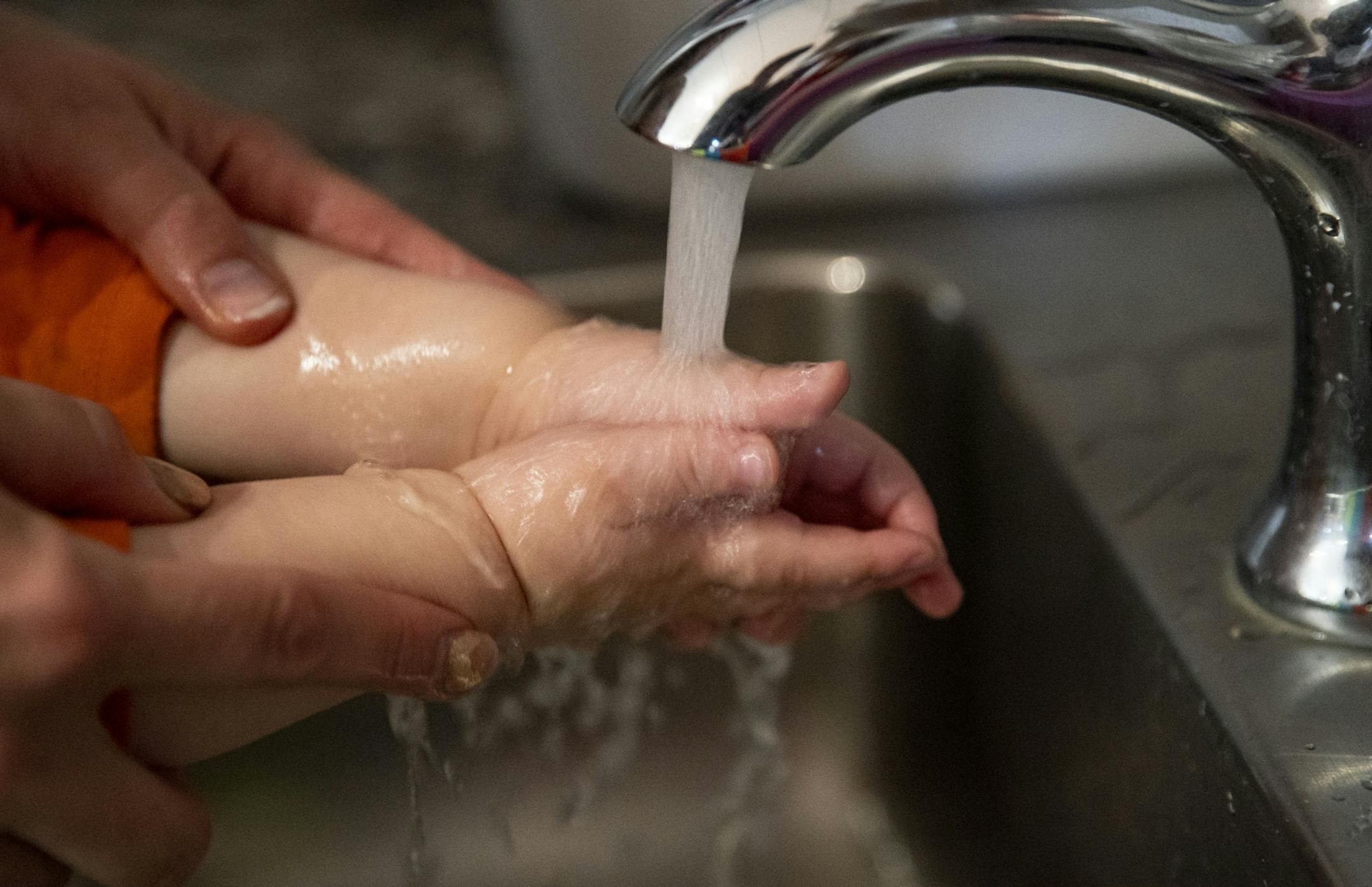 April Westman helped Charlotte wash her hands before snack time at Aunty's Child Care in Duluth, MN on Thursday.