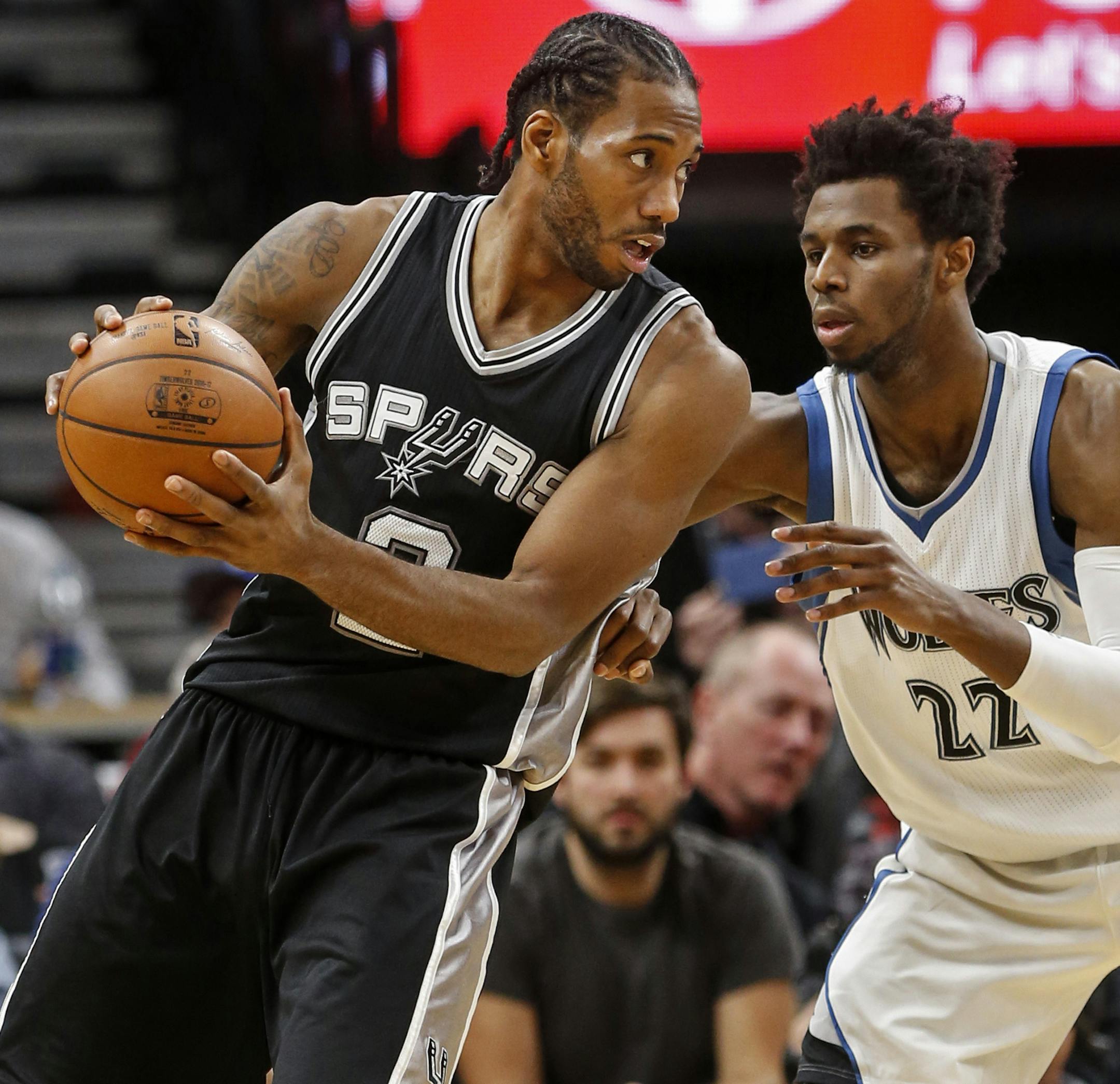San Antonio Spurs forward Kawhi Leonard (2) works against Minnesota Timberwolves forward Andrew Wiggins (22) in the second half of an NBA basketball game, Tuesday, Dec. 6, 2016, in Minneapolis. The Spurs won 105-91. (AP Photo/Bruce Kluckhohn)