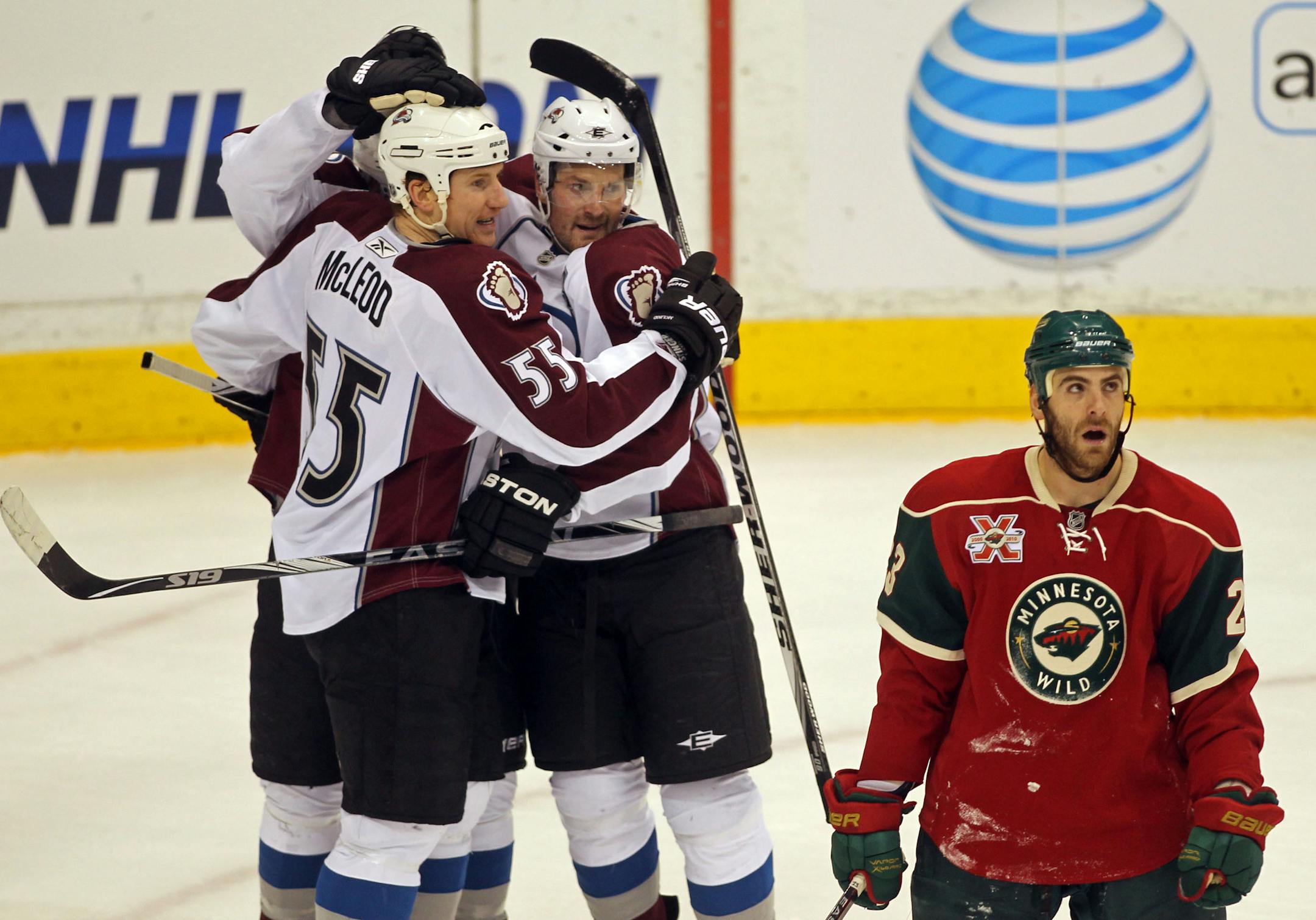 The Wild's Eric Nystrom (23) reacts to a power-play goal by Colorado's Milan Hejduk, middle, with teammate Cody McLeod (55).