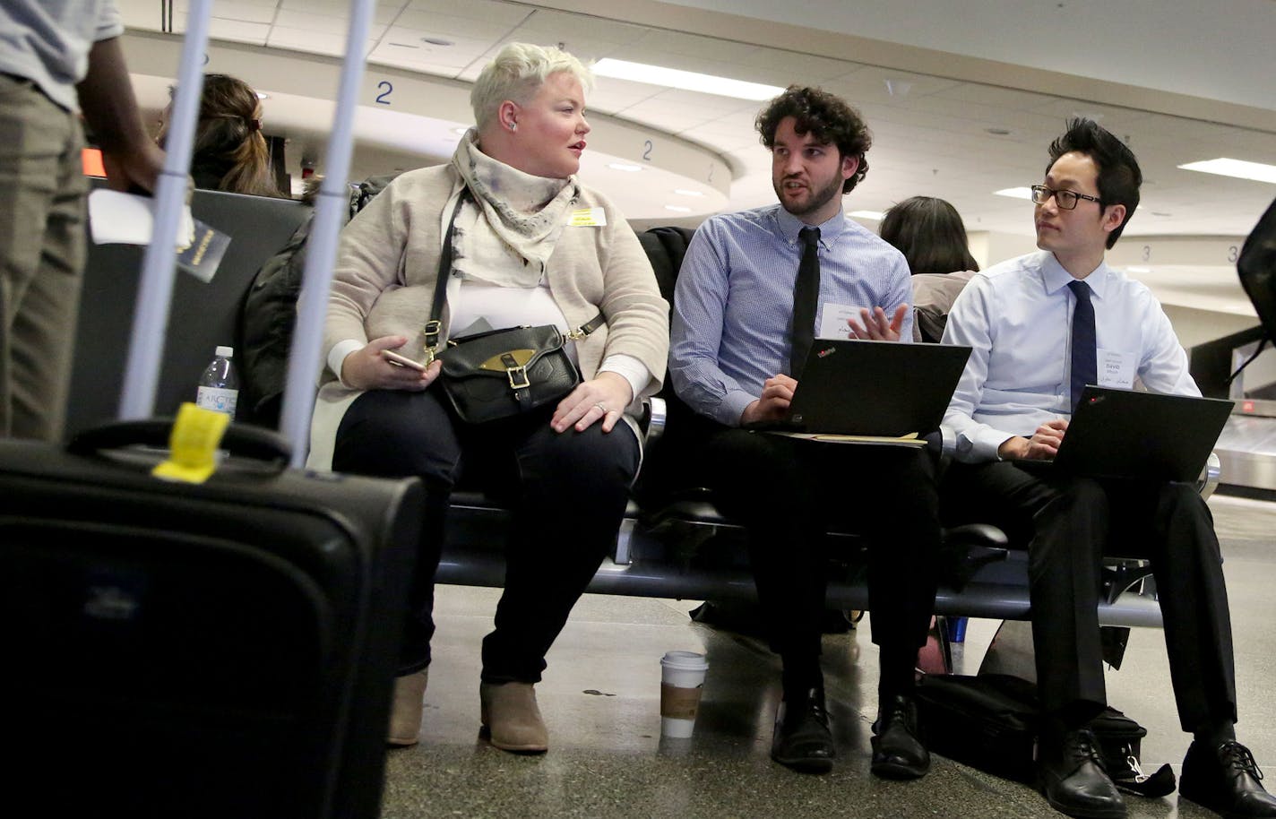 Tara Murphy, seated, left to right, Kyle Luebke and David Moon, volunteer attorneys for the University of Minnesota Law School&#x2019;s Center for New Americans, talk while waiting for refugees and visa holders hoping to get to the U.S. while President Trump&#x2019;s travel ban is held up in the courts while waiting near the International Arrival area in baggage claims at MSP Tuesday, Feb. 7, 2017, in Minneapolis, MN.] DAVID JOLES &#xef; david.joles@startribune.com A few attorneys wait at the ai