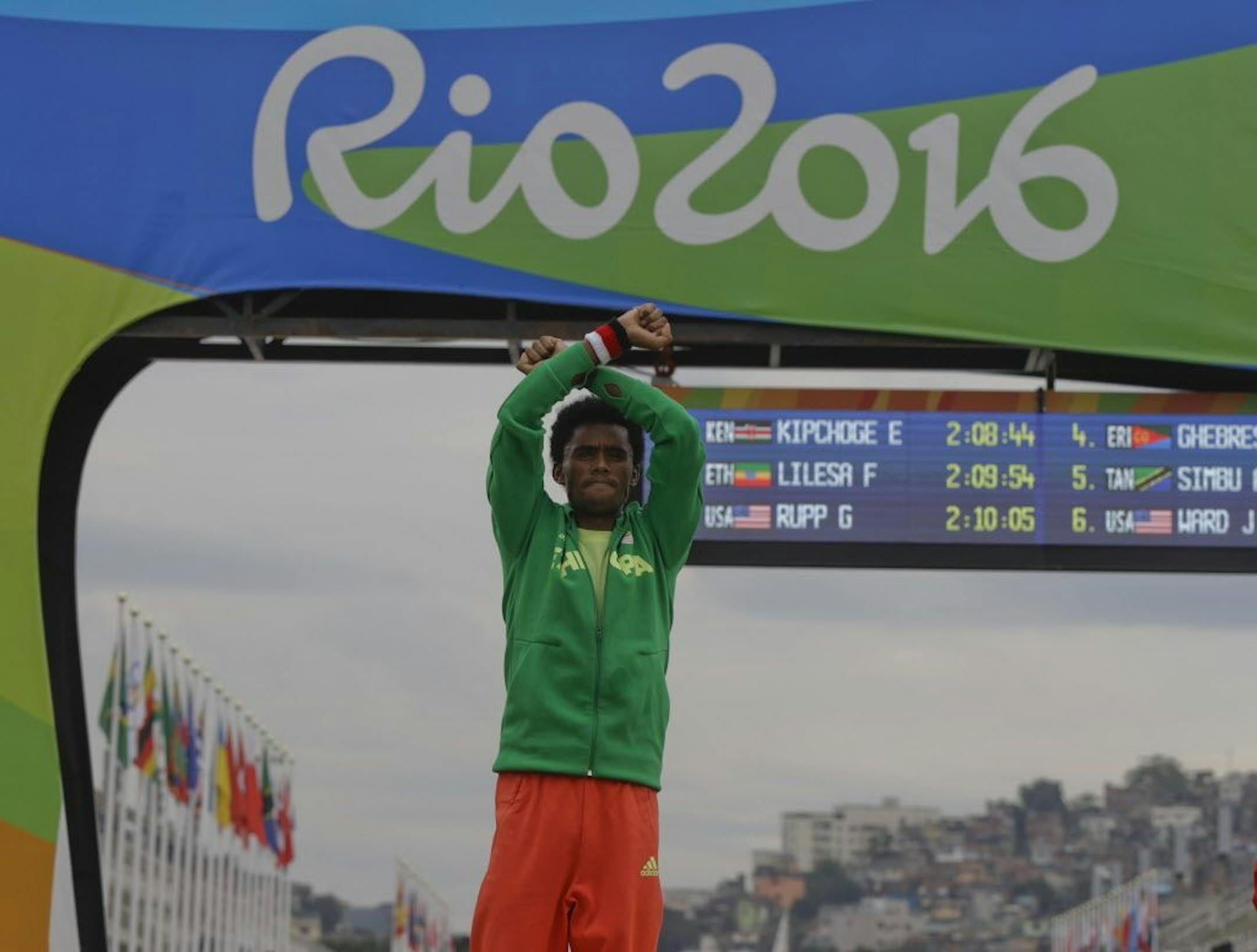 Silver medal Ethiopia's Feyisa Lilesa, crosses his arms as he celebrates on the podium after the men's marathon at the 2016 Summer Olympics in Rio de Janeiro, Brazil, Sunday, Aug. 21, 2016.