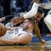 San Antonio Spurs guard Patty Mills (8) tries to get a loose ball from Minnesota Timberwolves center Cole Aldrich (45) and succeeds in getting a jump 