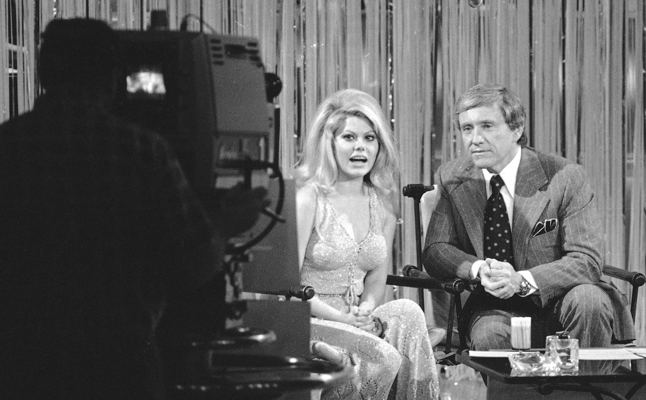Talk show host Merv Griffin is seen on his show "The Merv Griffin Show," with singer Charo, March 20, 1974, in Los Angeles. (AP Photo/David F. Smith) ORG XMIT: APHS101926