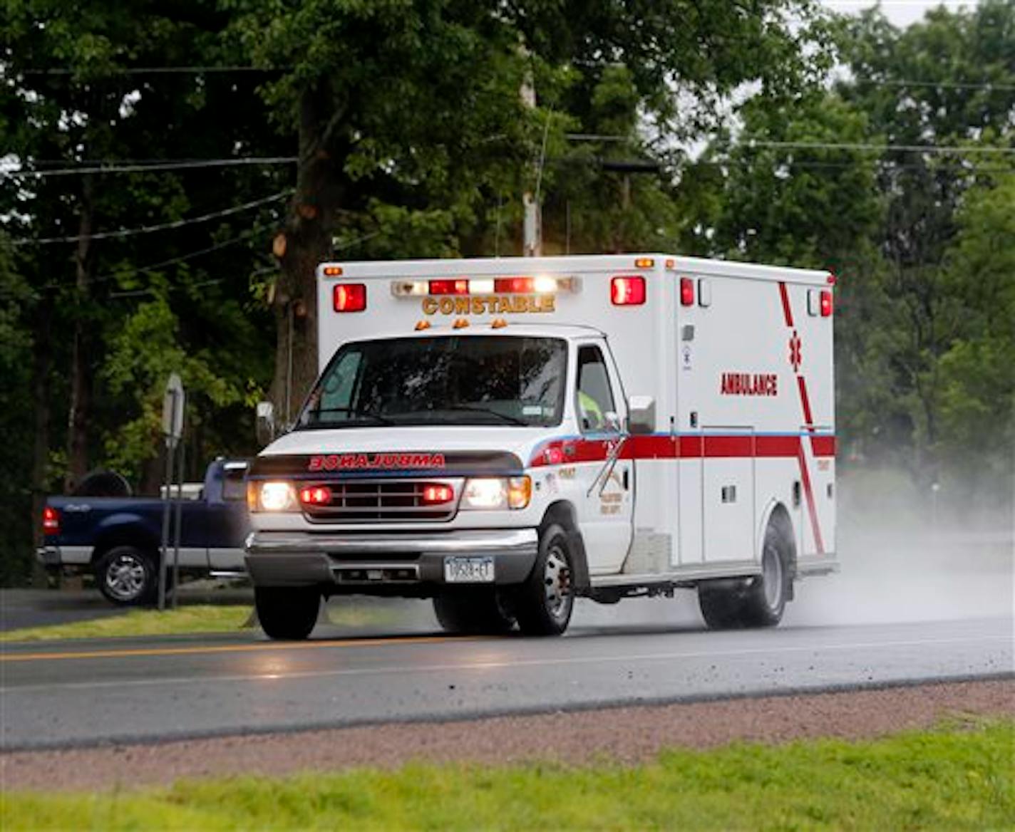 Police escort an ambulance from an area where law enforcement officers were searching for David Sweat, one of two convicted murderers who broke out of a maximum-security prison near the Canadian border, Sunday, June 28, 2015, in Constable, N.Y. The other inmate, Richard Matt, was shot three times in the head when he was confronted by authorities on Friday. (AP Photo/Mike Groll)