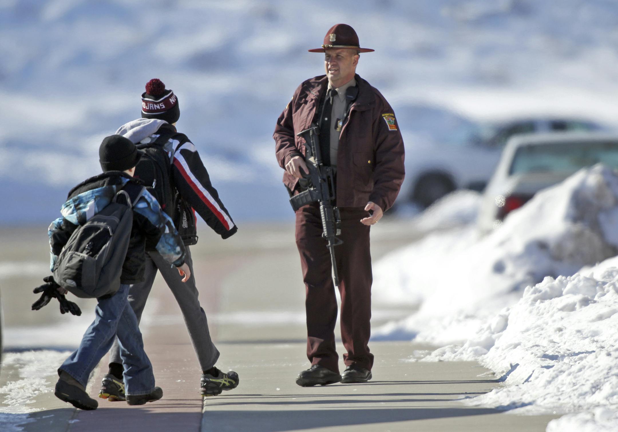 A state patrol officer keeps an eye on students who were bused into the school Wednesday, March 20, 2013, at New Prague Middle School in New Prague, MN.] (DAVID JOLES/STARTRIBUNE) djoles@startribune.com A report of a school shooting on a 911 at New Prague Middle School put the school on a code red lock down Wednesday, March 20, 2013, and made for tense moments for law enforcement, students and their parents. It turned out to be a hoax. ORG XMIT: MIN1303201120032237