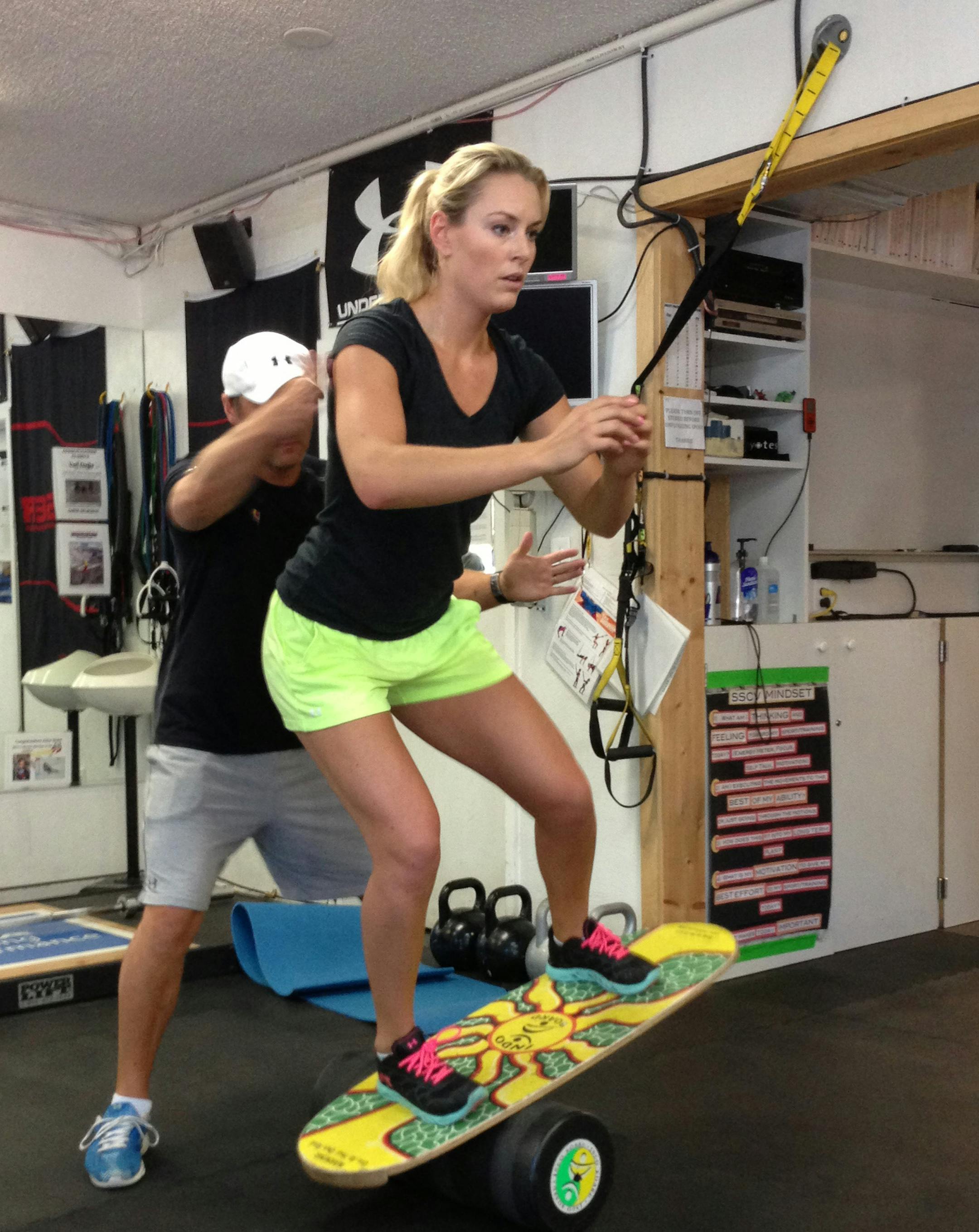 Lindsey Vonn works out with Red Bull coach Martin Hager in Vail, Colo., Wednesday Aug. 28, 2013. Vonn's surgically repaired right knee is nearly fully healed and she plans to ski this weekend. The four-time overall World Cup champion is looking at a possible return to competition in late November in Beaver Creek, Colo. That's three months ahead of the Sochi Olympics, where she will defend her downhill title. (AP Photo/Pat Graham) ORG XMIT: MIN2013082815272018