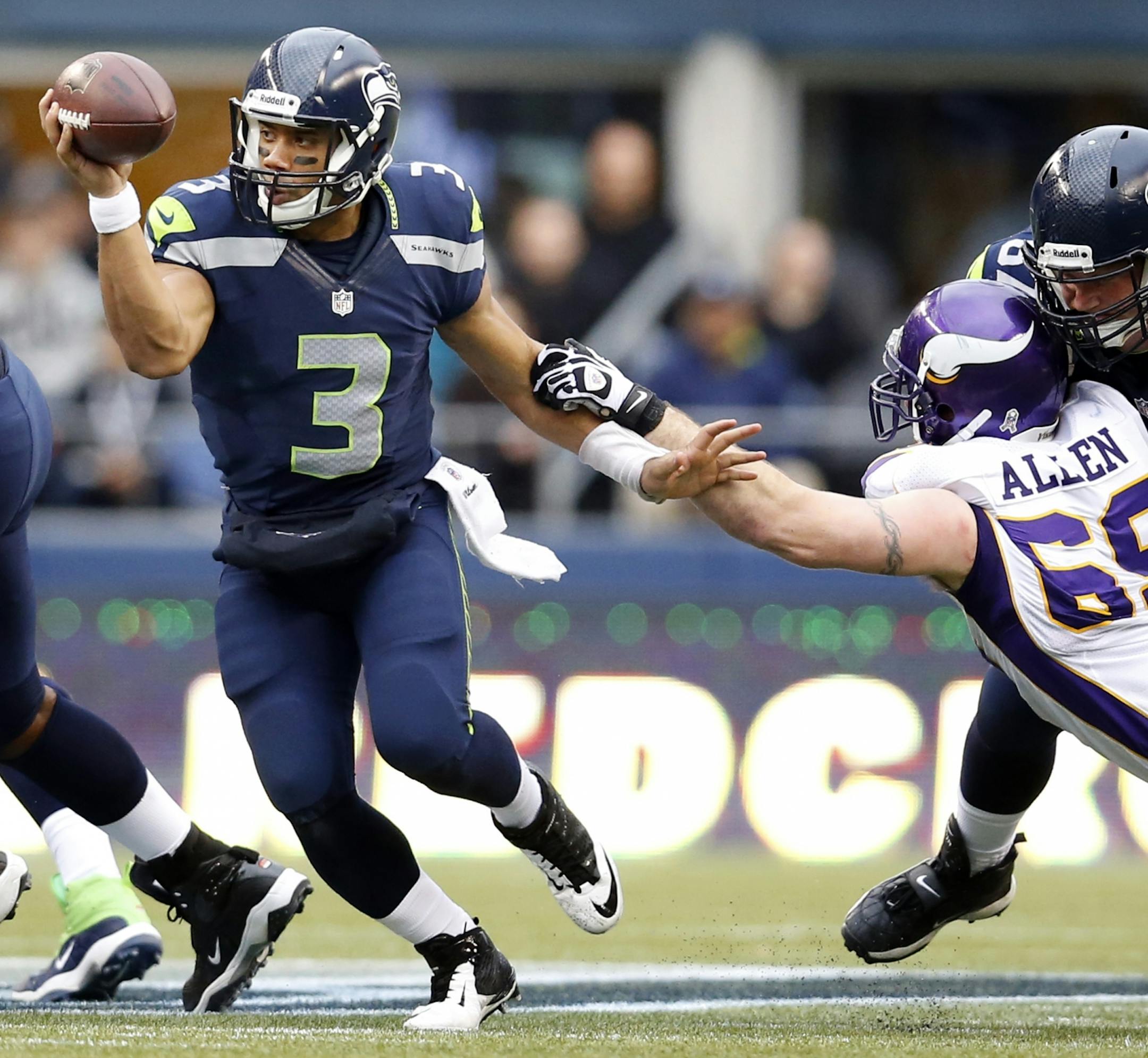 Seattle quarterback Russell Wilson (3) evaded the grasp of Vikings defensive end Jared Allen in the third quarter. Seattle beat Minnesota 30-20.
