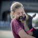 Julia Maynard of Winona, received loving from her goat "April" as she carried it to the goat barn at the Minnesota State Fairgrounds, Wednesday, Augus
