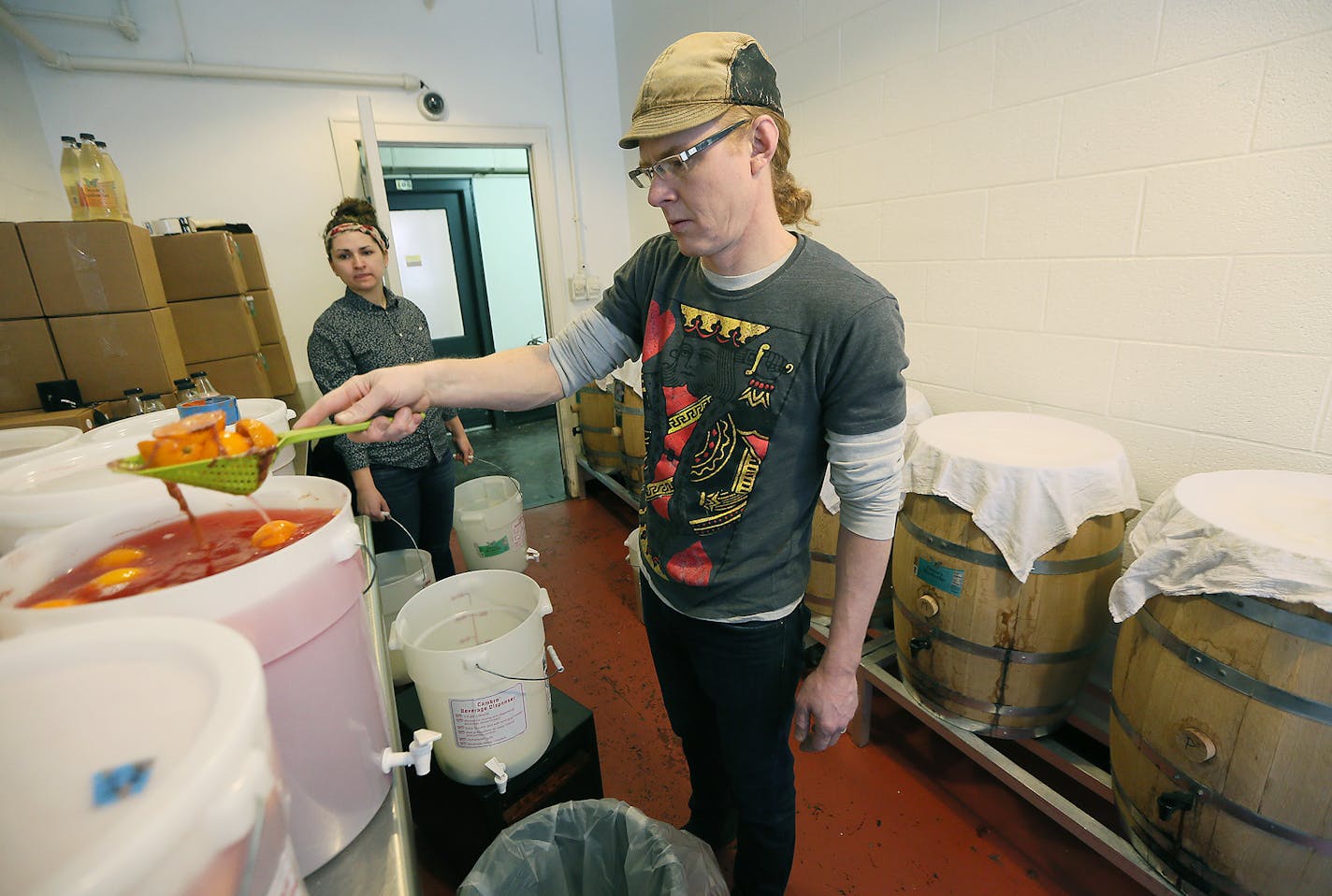 Bryan Bertsch of Deanes Kombucha removed oranges for one of his fruit kombucha recipes.