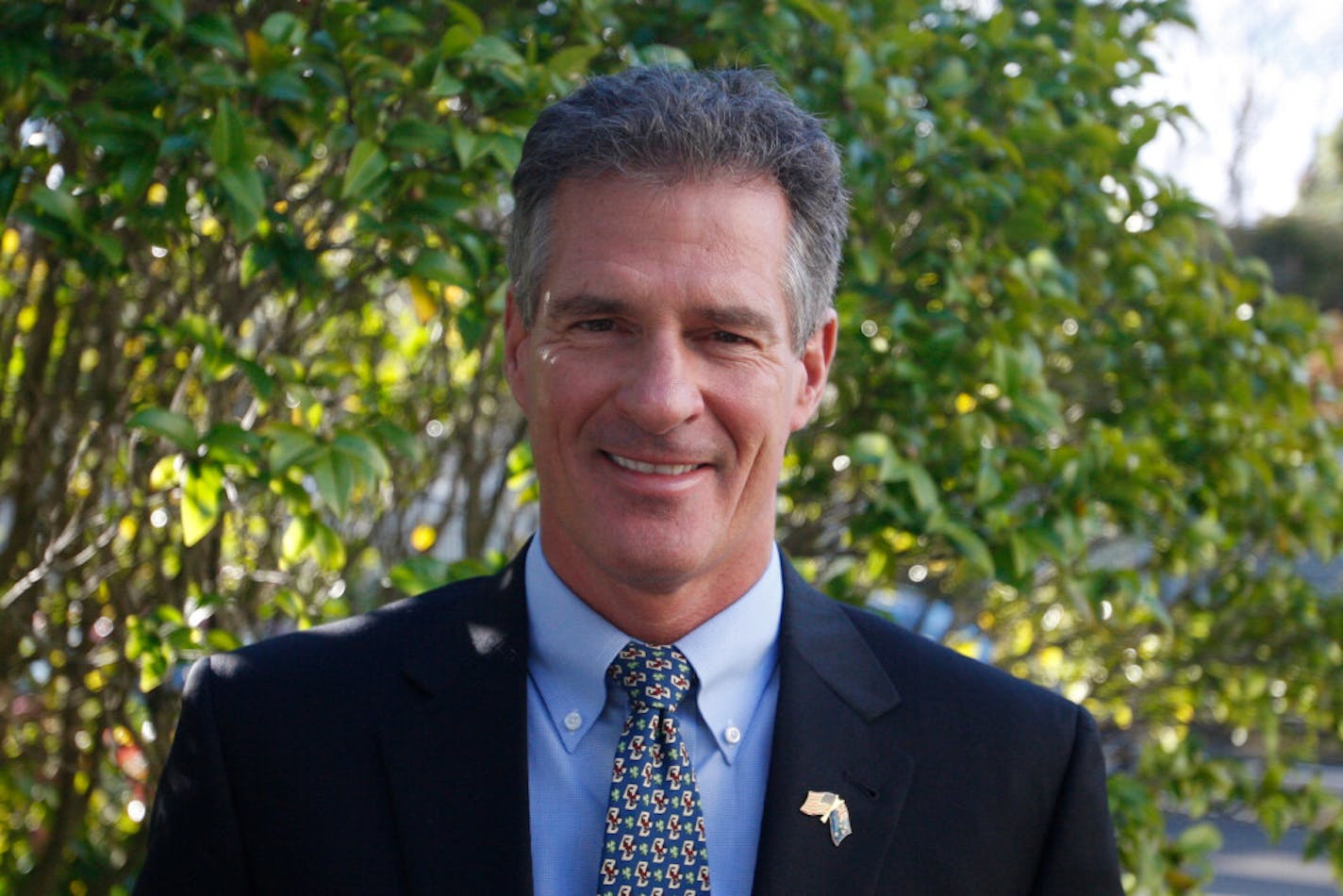 In this July 11, 2017, photo, U.S. Ambassador to New Zealand Scott Brown poses for a photograph at the U.S. Embassy in Wellington, New Zealand. The United States government paid for Brown and his wife, Gail, to fly domestically in New Zealand on a private jet so they could avoid going into quarantine at the border, documents show.