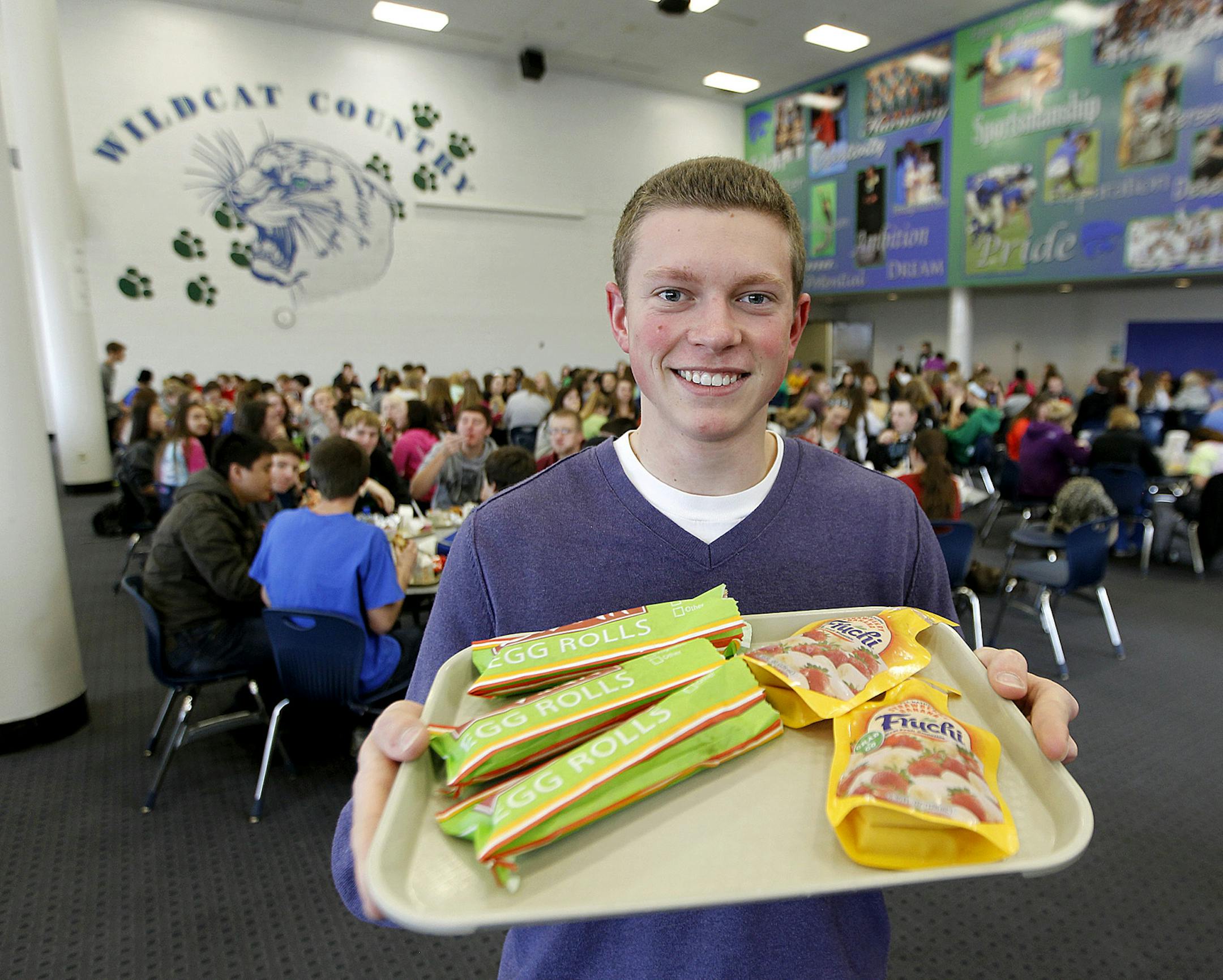 Erik Hillesheim, an Eagan High School senior showed off some of the menu item he created that his classmates will be eating every day for lunch thanks to his participation in a mentorship program, Monday, November 25, 2013 in Eagan, MN. Hillesheim learned about and entrepreneurship and food service thanks to his mentor, Pat McCoy, who works for Schwan's, the same company that makes many school lunch items served in the district.(ELIZABETH FLORES/STAR TRIBUNE) ELIZABETH FLORES • eflores@st