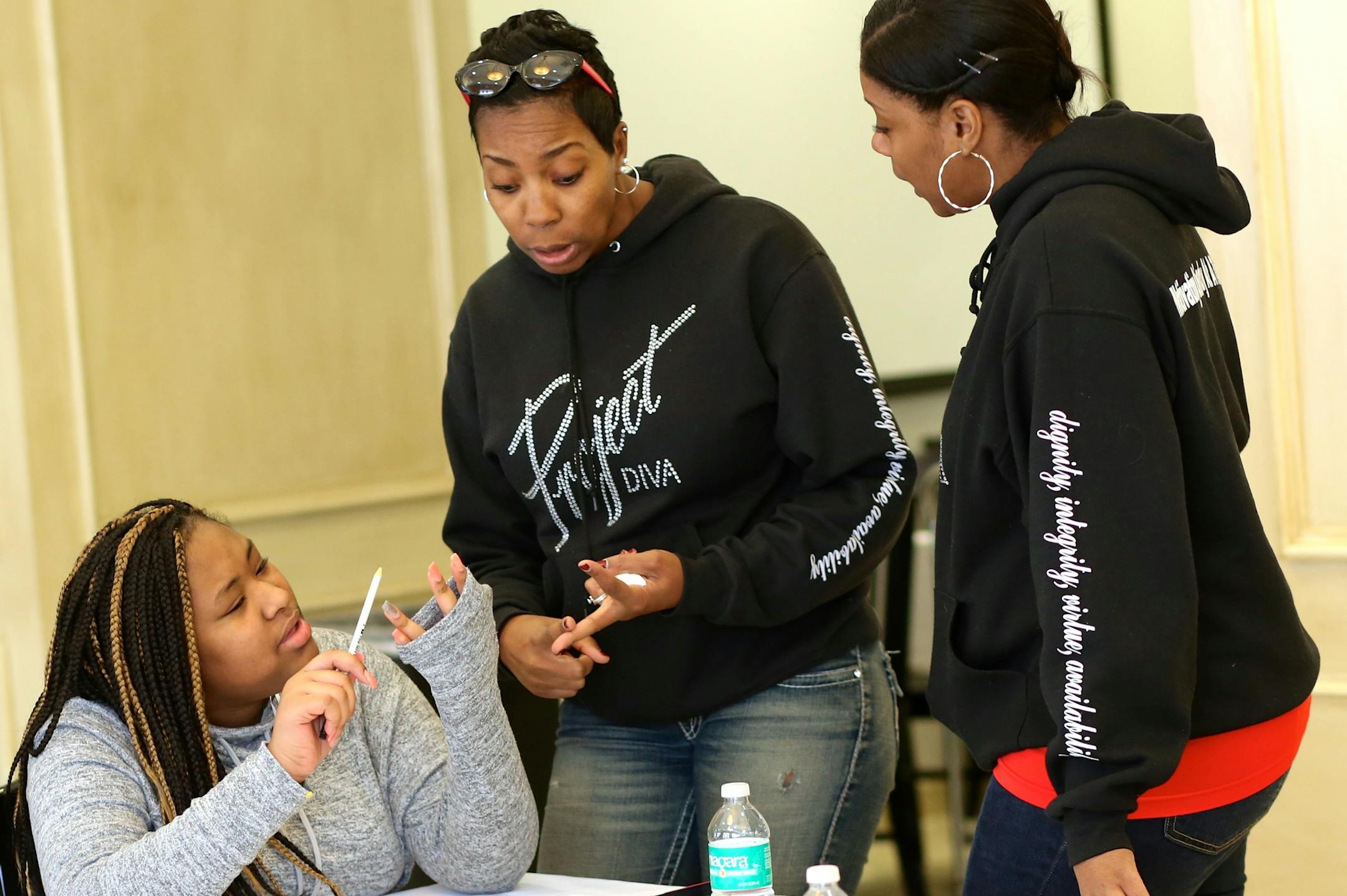Neda Kellogg, center, founded Project Diva to help mentor girls and offer them the resources she didn't have when she was young.
