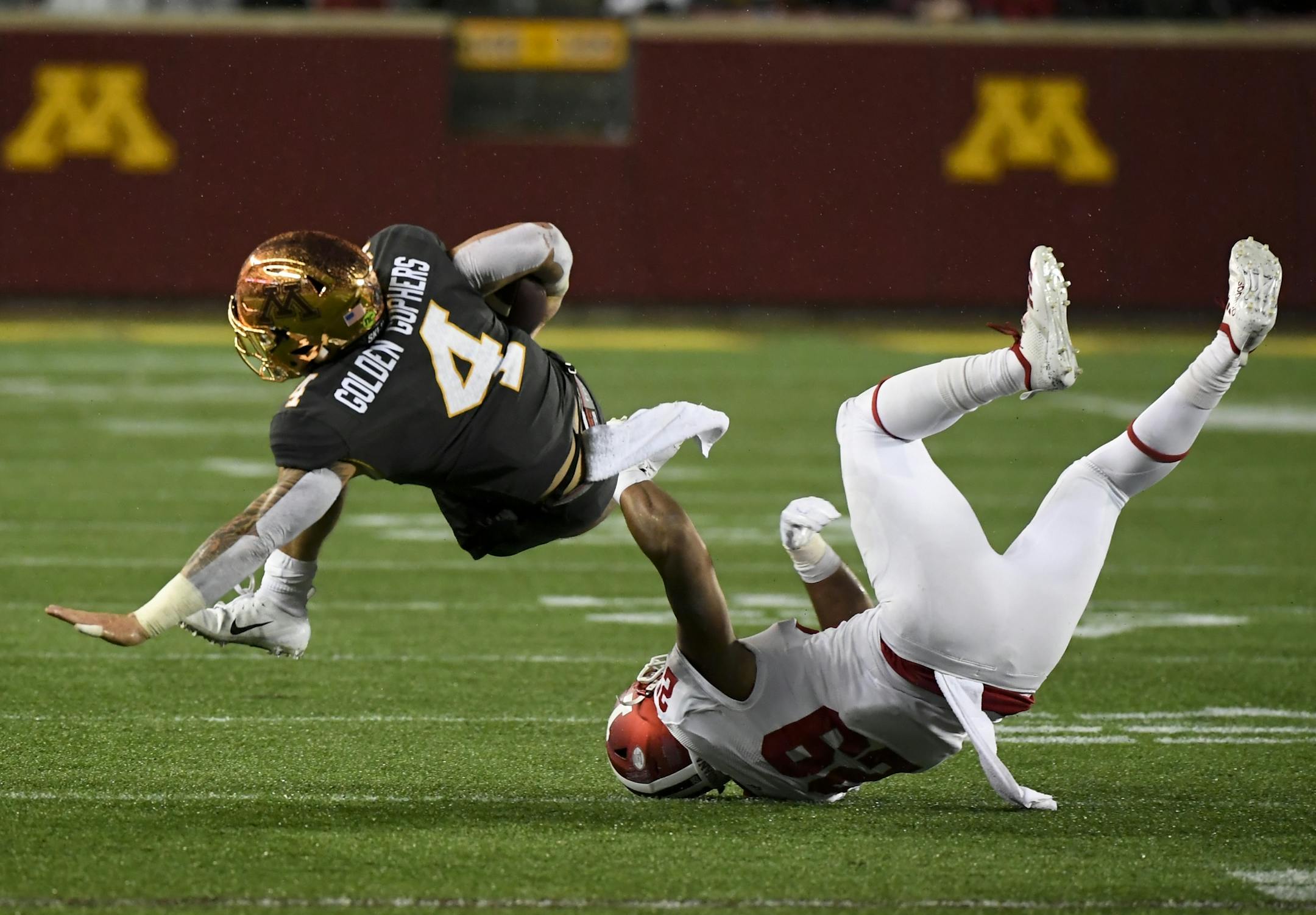 Indiana Hoosiers defensive back Khalil Bryant (29) was able to trip up Minnesota Golden Gophers running back Shannon Brooks (4) but Brooks was able to get the first down in the second quarter.