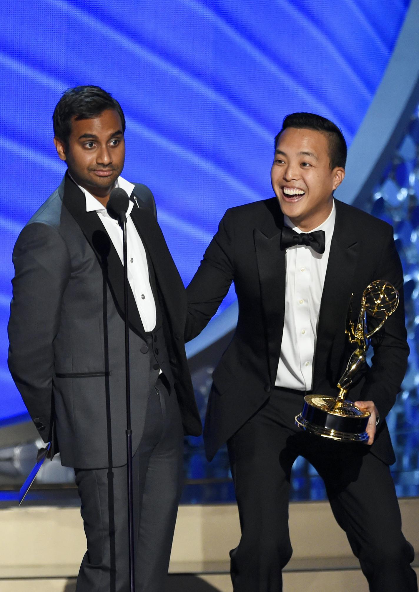 Aziz Ansari, left, and Kelvin Yu accept the award for outstanding writing for a comedy series for &#x201c;Master of None&#x201d; at the 68th Primetime Emmy Awards on Sunday, Sept. 18, 2016, at the Microsoft Theater in Los Angeles. (Photo by Chris Pizzello/Invision/AP)