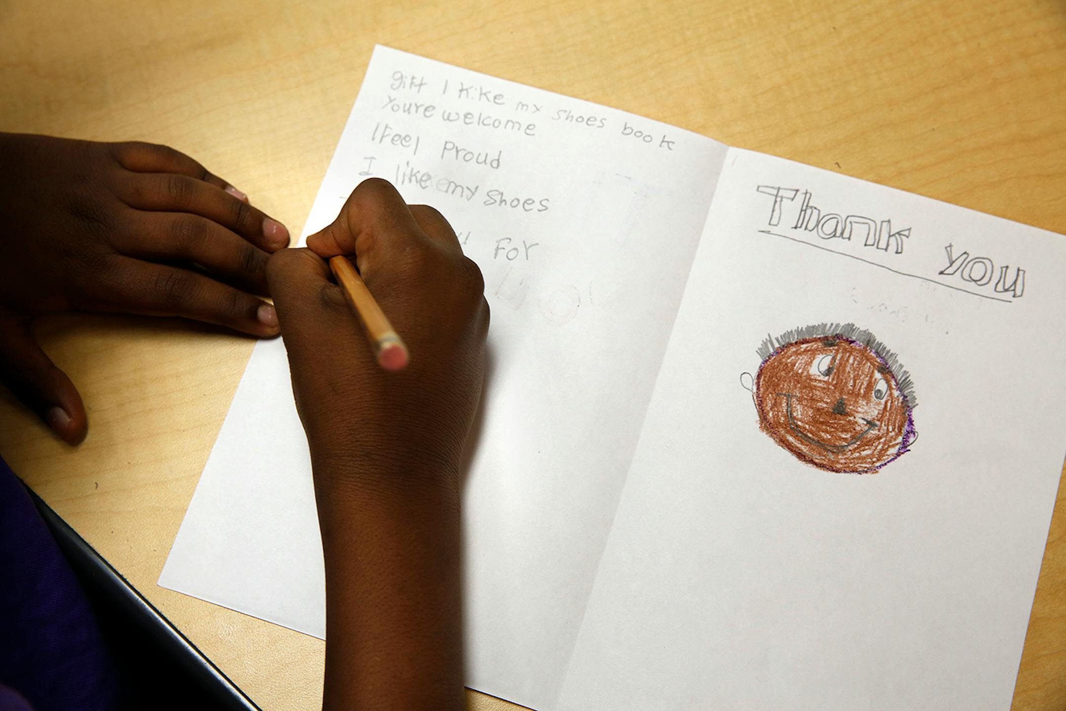 Mubashir Ali, 8, writes a thank you letter during an English language development lesson in Stephany Jallo's classroom at Andersen United Community School in Minneapolis. ] LEILA NAVIDI leila.navidi@startribune.com / BACKGROUND INFORMATION: Tuesday, October 21, 2014. The Minneapolis school district launched a new program last school year with sheltered classrooms and instruction in both Somali and English for new refugee arrivals, many of whom come with little formal education.