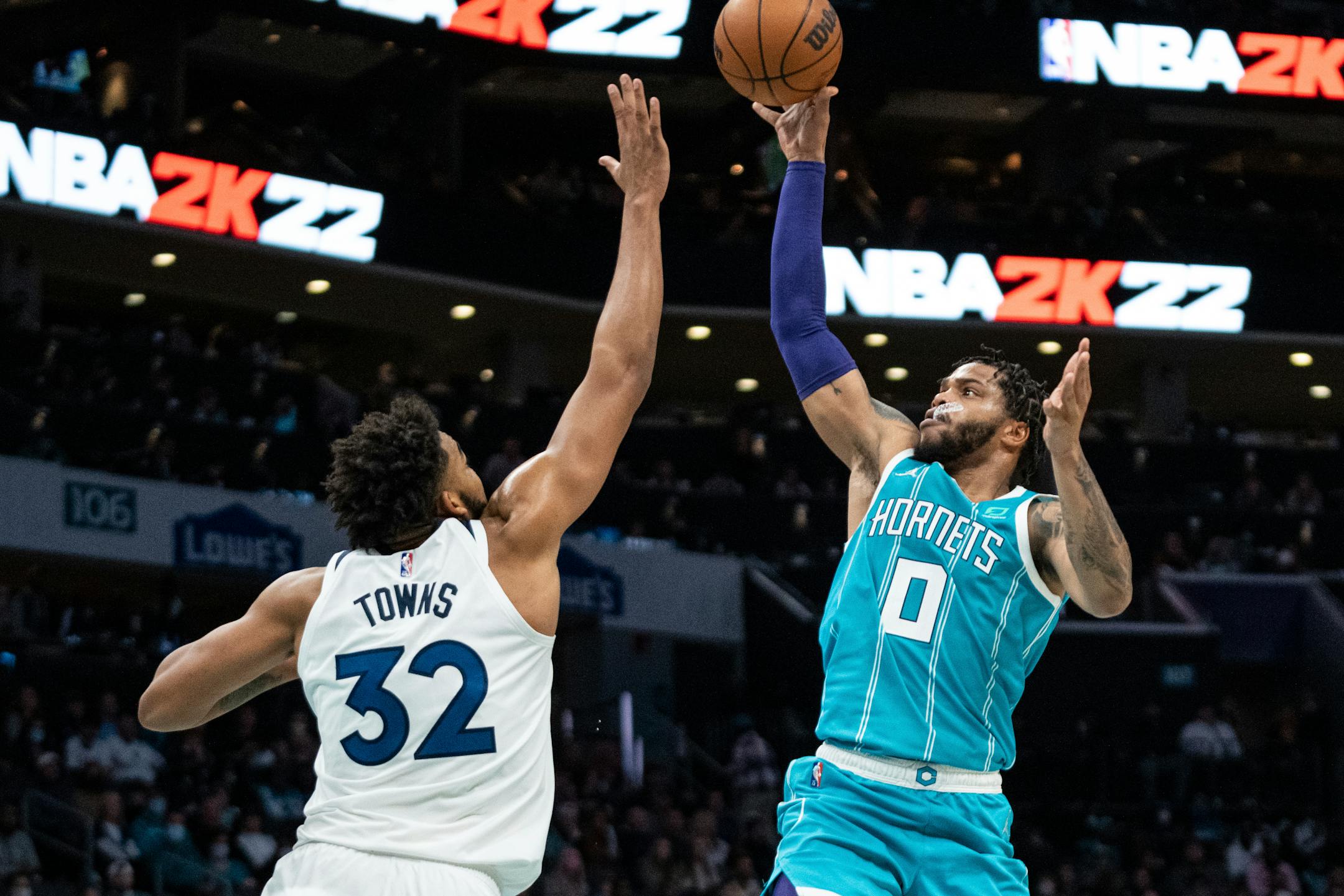 Charlotte forward Miles Bridges shoots over Timberwolves center Karl-Anthony Towns during the first half