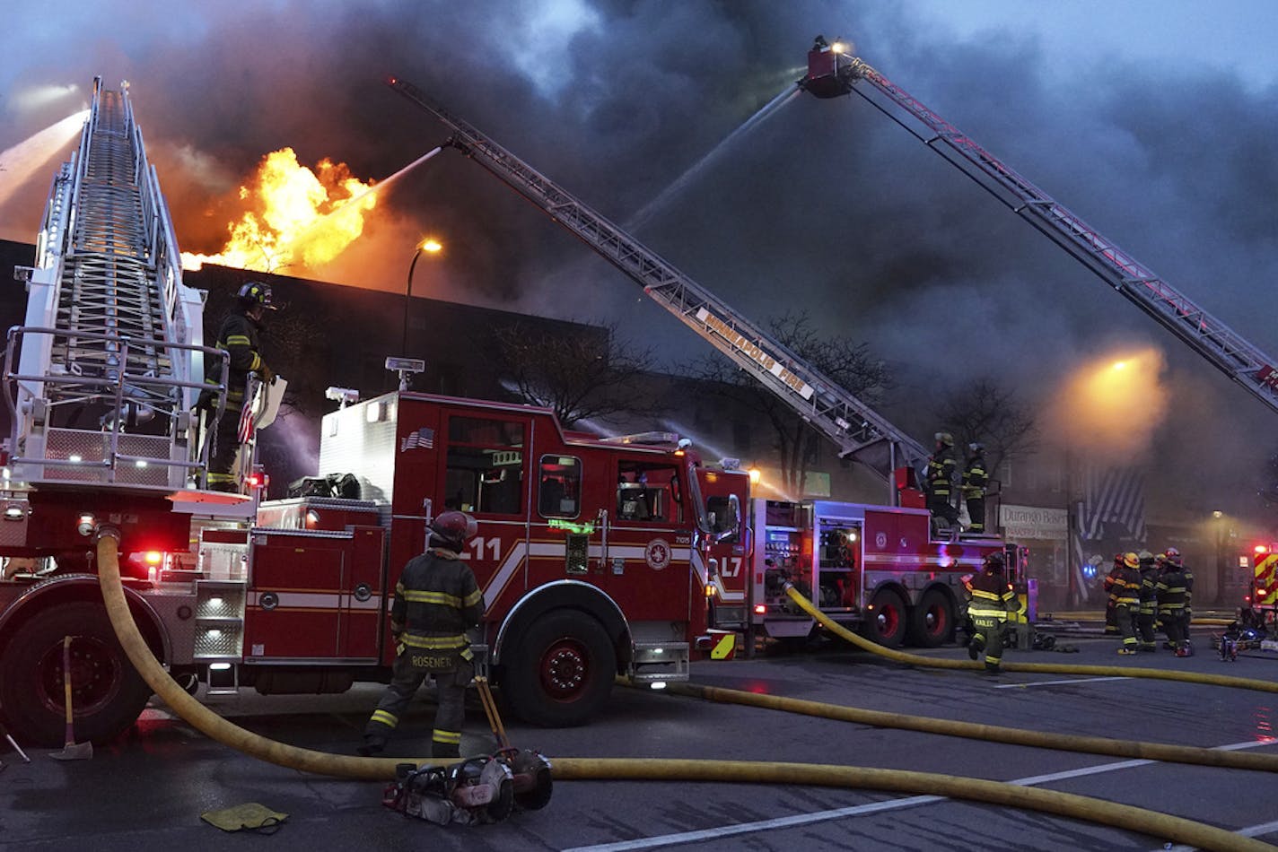 Minneapolis firefighters battle a fire in the 2400 block of Central Avenue, Sunday, March 22, 2020, in Northeast Minneapolis.