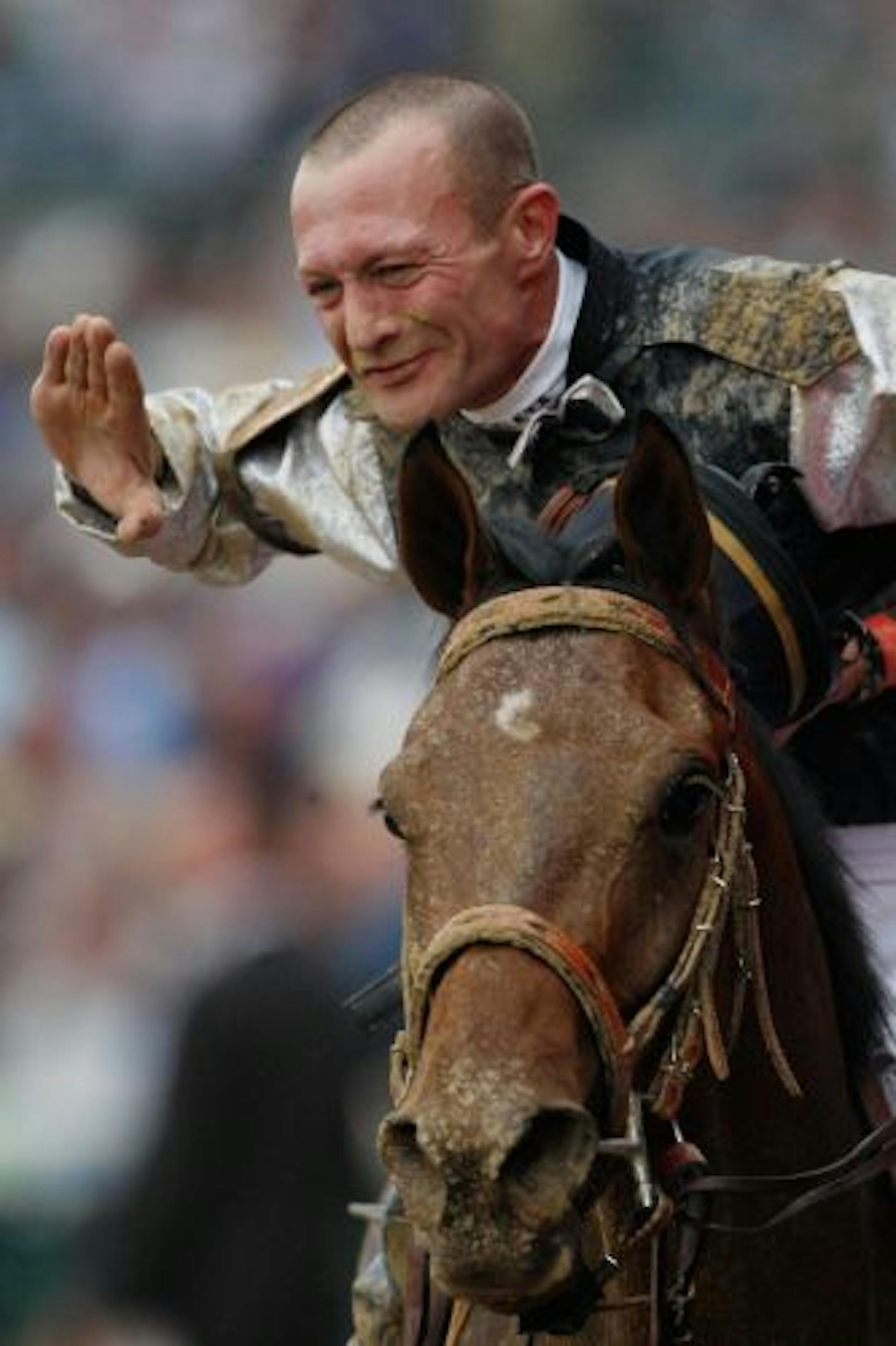 Jockey Calvin Borel atop Mind That Bird celebrates his win.