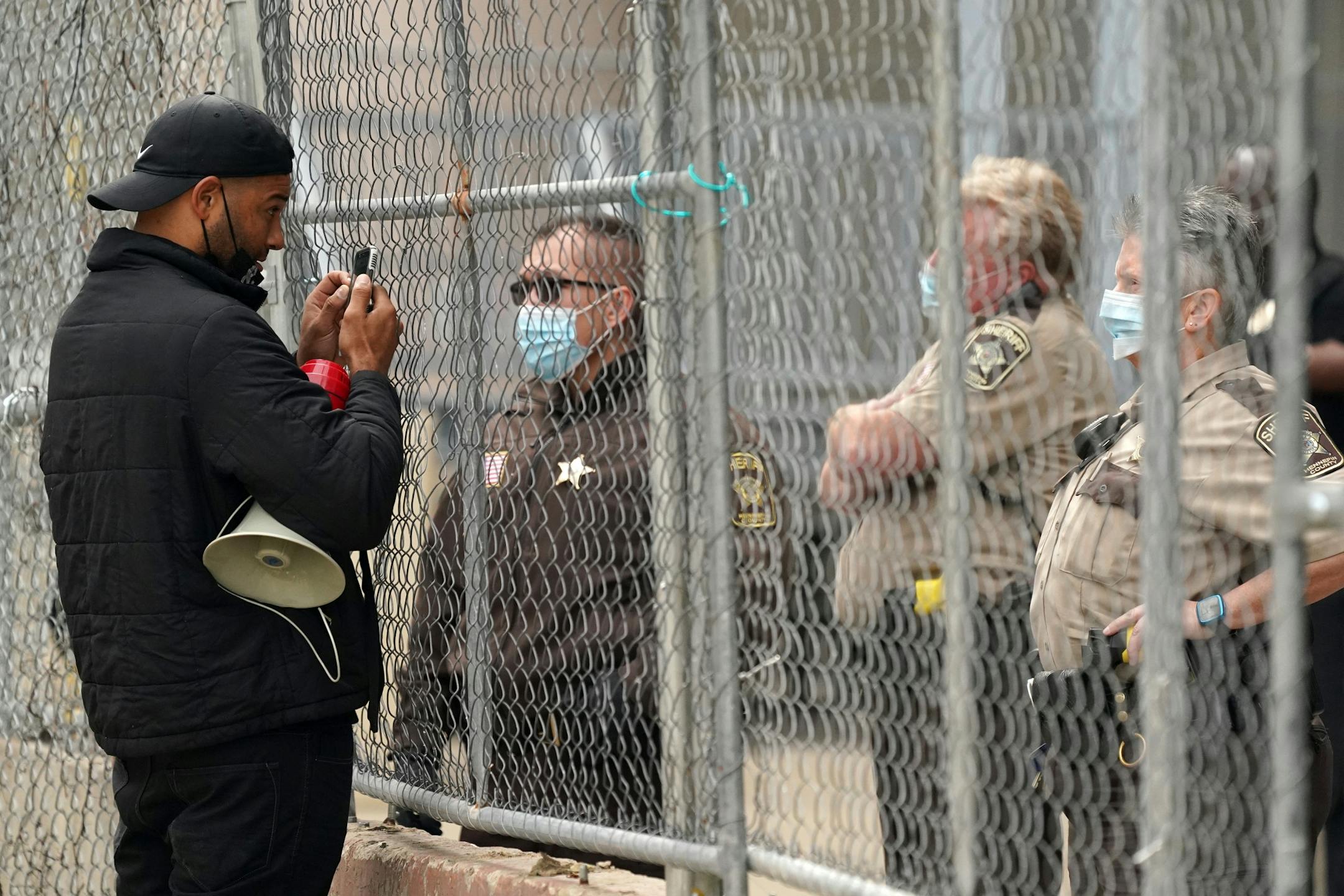 A protester mocked sheriff's deputies as they stood guard behind the Hennepin County Family Justice Center in downtown Minneapolis for Friday's hearing.