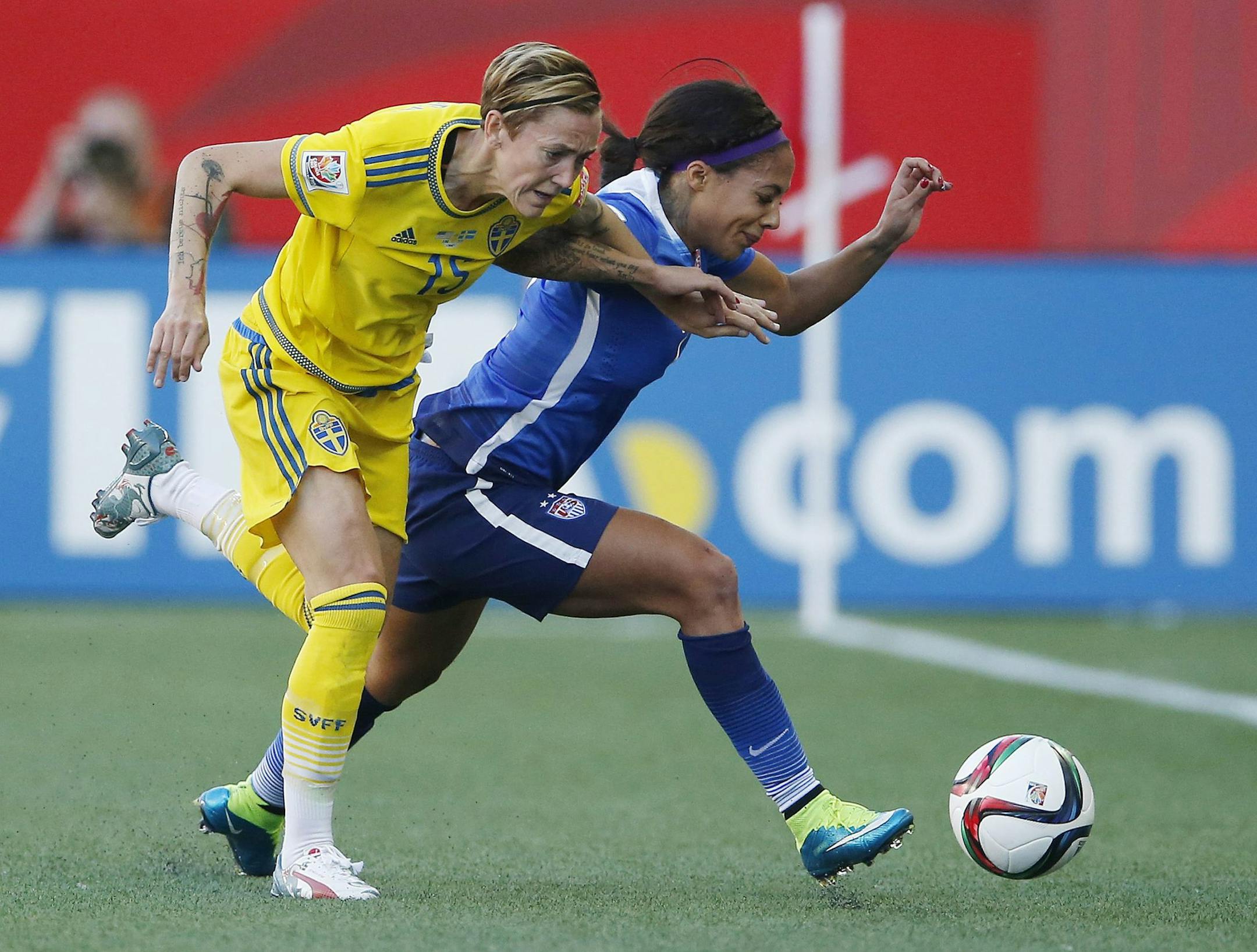 Sweden's Therese Sjogran (15) and United States' Sydney Leroux chase down the ball during first-half FIFA Women's World Cup soccer game action in Winnipeg, Manitoba, Canada, Friday, June 12, 2015. (John Woods/The Canadian Press via AP) MANDATORY CREDIT