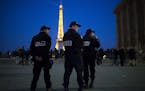 French police officers patrol at Trocadero plaza with the Eiffel Tower in the background in Paris, Friday, April 21, 2017. The Champs-Elysees gunman w