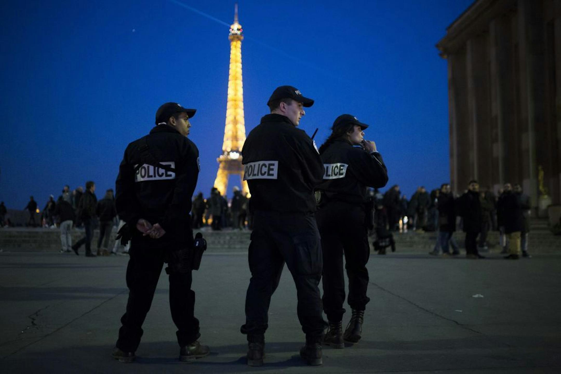French police officers patrol at Trocadero plaza with the Eiffel Tower in the background in Paris, Friday, April 21, 2017. The Champs-Elysees gunman who shot and killed a police officer just days before France's presidential election was detained in February for threatening police but then freed, two officials told The Associated Press on Friday.
