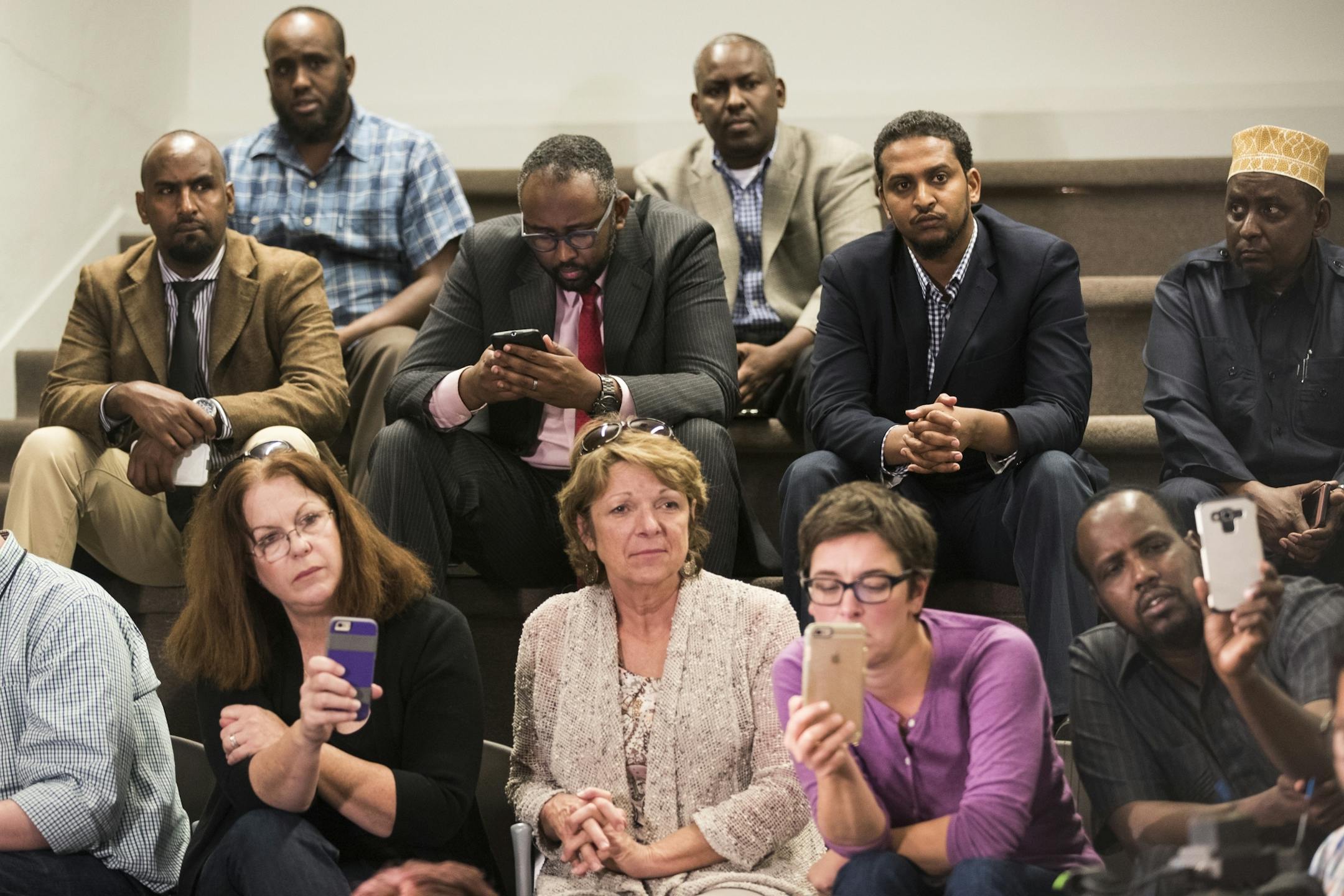 Community members listen during a press conference at St. Cloud City Hall.