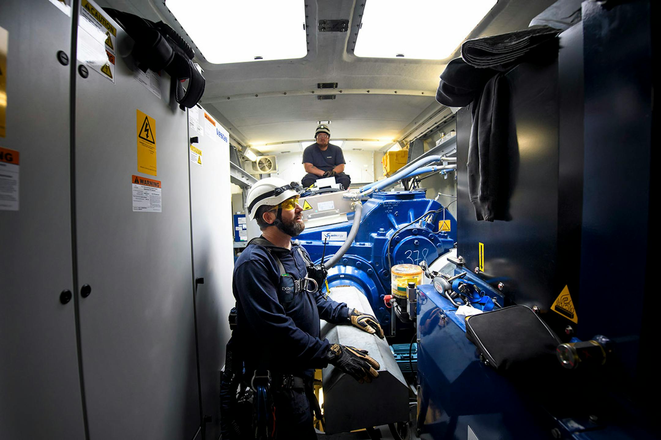In the nacelle of a Vestas wind turbine, Will Osborn and Chris Berg talked over what needed to be done there.