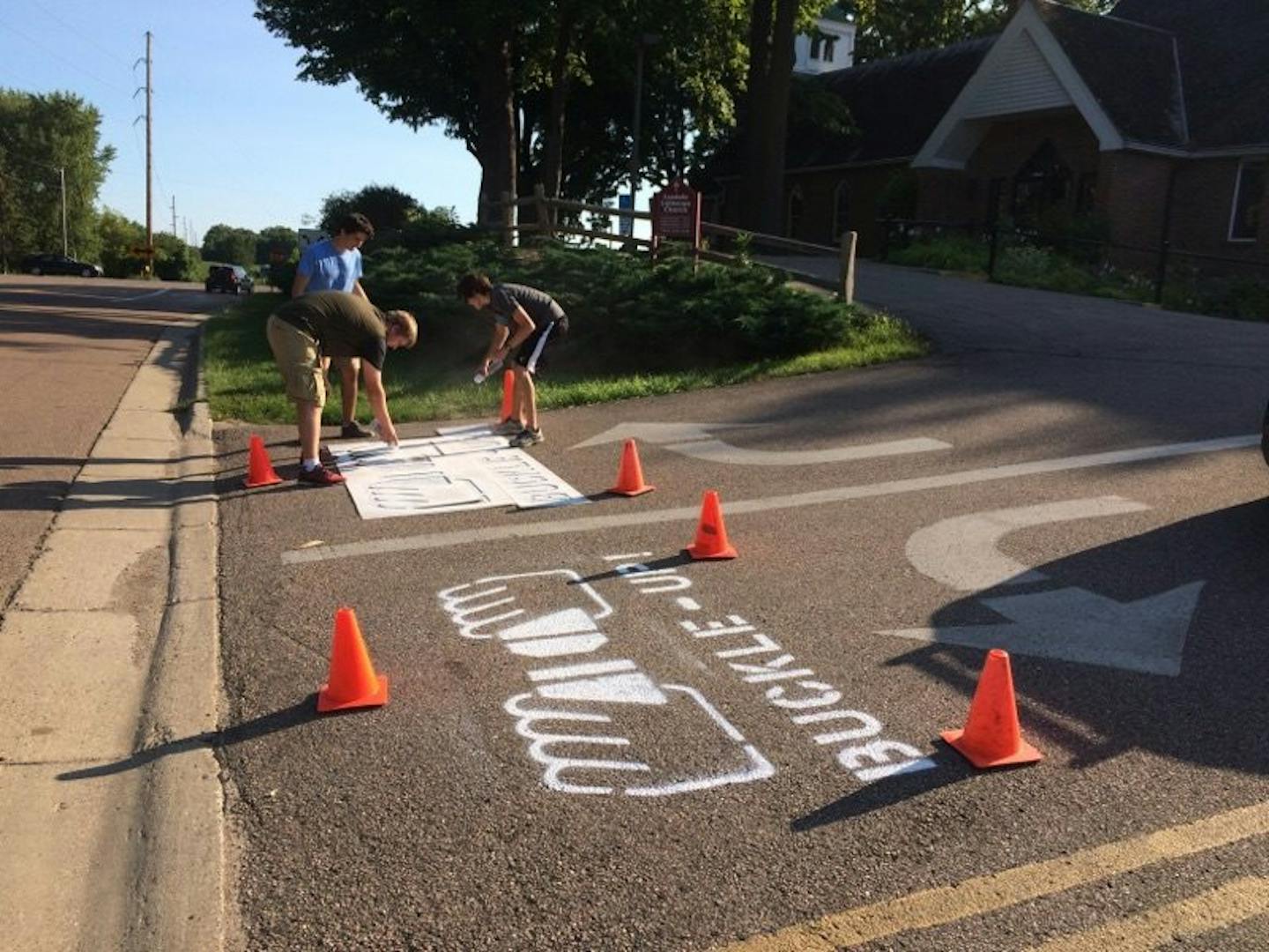 Photo: West Hennepin Public Safety Three Delano High School students painted images on parking lot exits of businesses, churches and government centers in their area to remind motorits to buckle up.