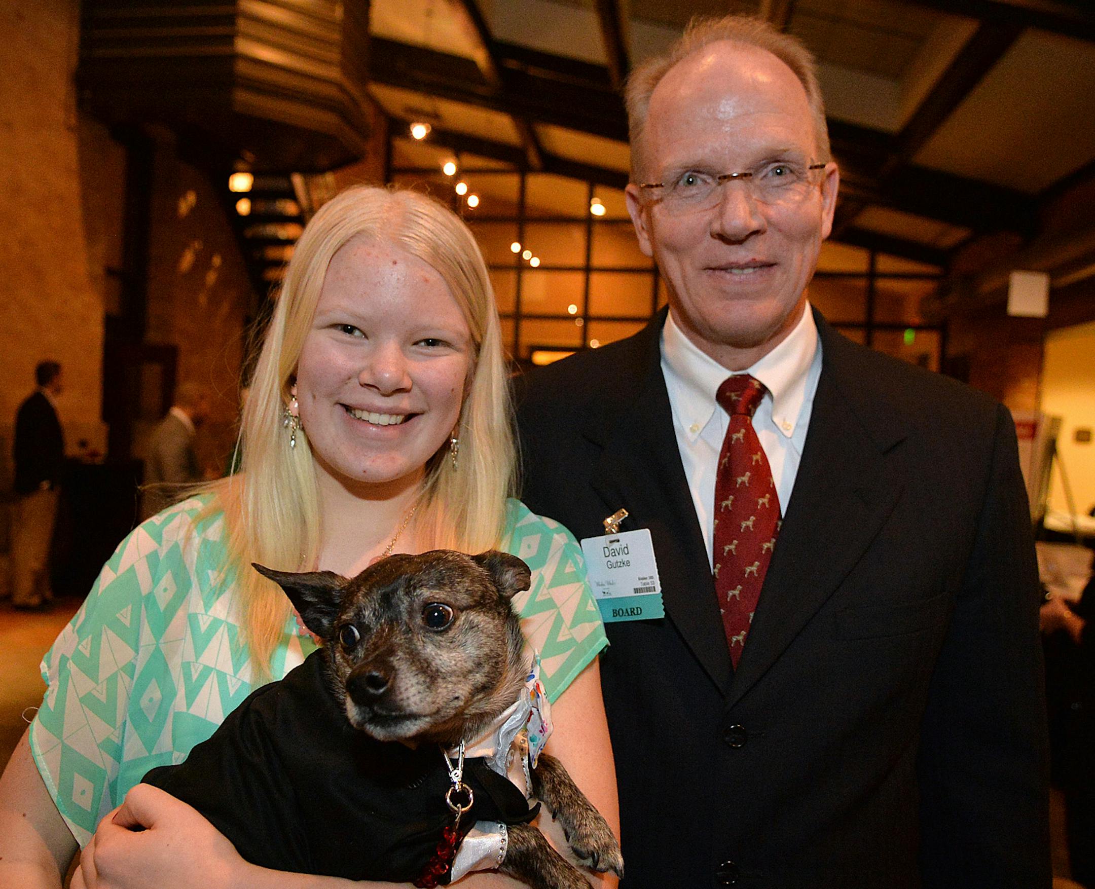 David Gutzke, member of the Board of Directors of the Animal Humane Society, and his daughter, Annika with Buddy, a Boston Terrier mix rescue. ] (SPECIAL TO THE STAR TRIBUNE/BRE McGEE) **David Gutzke (Board Member on the Board of Directors of the Animal Humane Society), Annika Gutzke (David's daughter), Buddy (Boston Terrier mix, rescue dog)