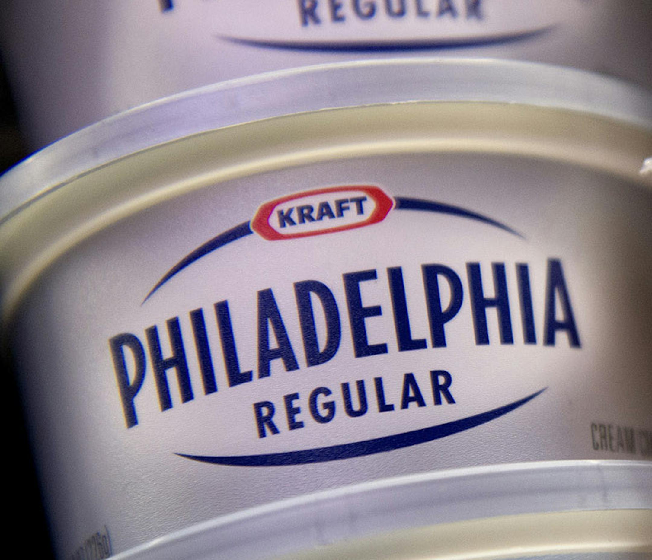 Kraft Foods Group Inc. Philadelphia cream cheese tubs and American cheese single cheese packages are arranged for a photograph in Fog Hill Market in San Francisco, California, U.S., on Tuesday, Feb. 5, 2013. Kraft Foods Group Inc. is expected to release earnings data Feb 7. Photographer: David Paul Morris/Bloomberg ORG XMIT: 161069298